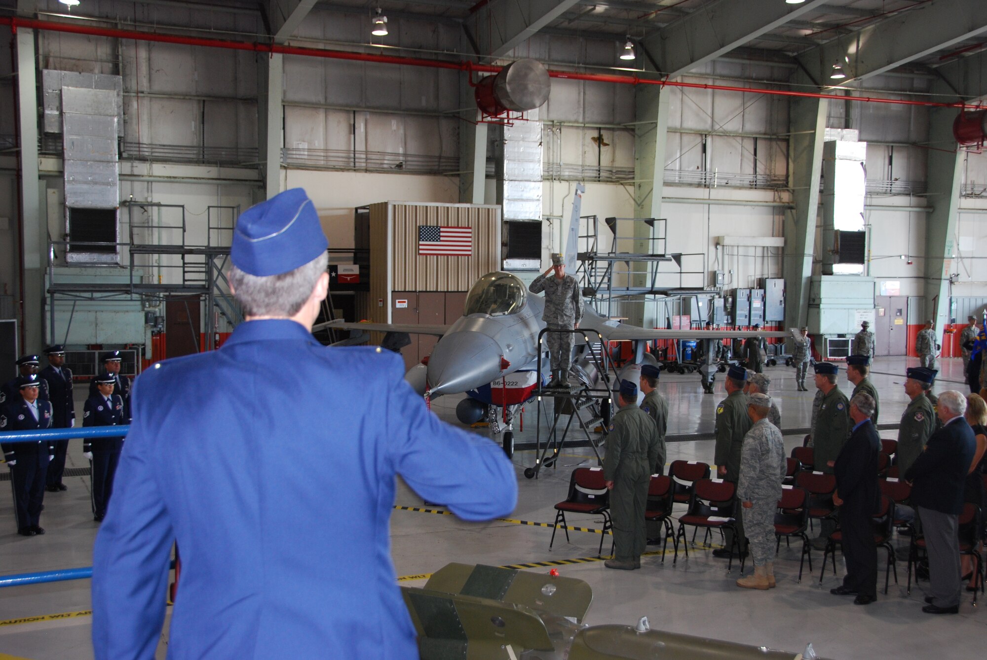 Colonel Ronald B. Miller (at left) salutes a crew chief as Colonel Miller's name is uncovered on his flagship. Colonel Miller was honored during his change of command ceremony Sunday, October 3 when he became the new commander of the 301st Fighter Wing. (U.S. Air Force Photo/SSgt Chris Bolen)