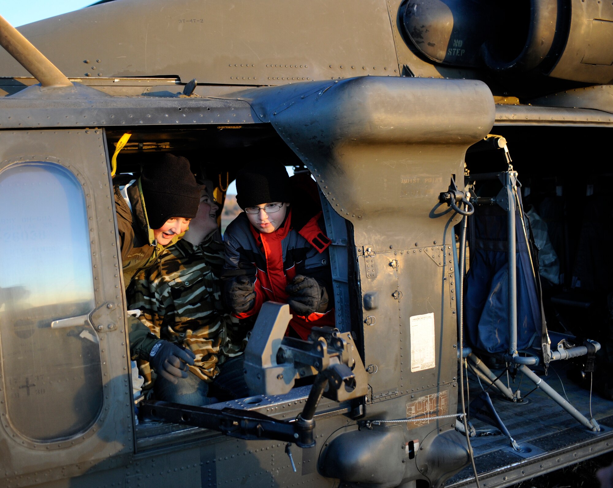 Three Scouts from local Boy Scout troop tour an UH-60 Black Hawk Sept. 28, 2010, Eielson Air Force Base, Alaska. The Black Hawk and its crew were waiting for dark to fulfill night training operations. The Scouts took that opportunity to view the Black Hawks features during a self guided tour. (U.S. Air Force photo/Senior Airman Willard E. Grande II)