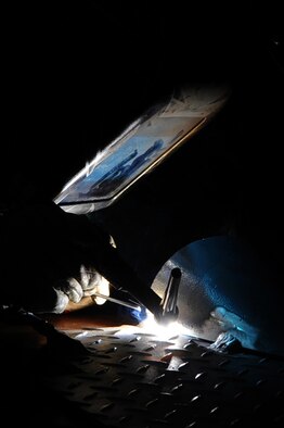 ELLSWORTH AIR FORCE BASE, S.D. – Airman 1st Class Shelly Jenkins, 28th Maintenance Squadron aircraft metals technology apprentice, repairs a floor panel for a bomb loader by using tungsten inert-gas welding, Sept. 30. TIG welding is a precise form of welding that can be performed on a variety of metals. (U.S. Air Force photo/Senior Airman Kasey Close)