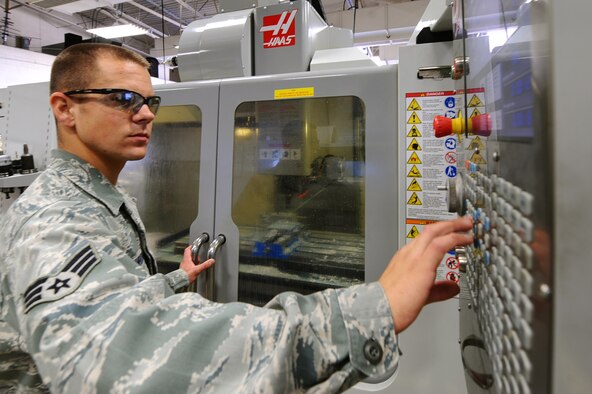 ELLSWORTH AIR FORCE BASE, S.D. – Senior Airman Nathan Schroeder, 28th Maintenance Squadron aircraft metals technology journeyman, adjusts the flow of coolant during milling of a spoiler bellcrank, Sept. 30. The coolant prevents the metal from overheating and damaging the part. (U.S. Air Force photo/Senior Airman Kasey Close)