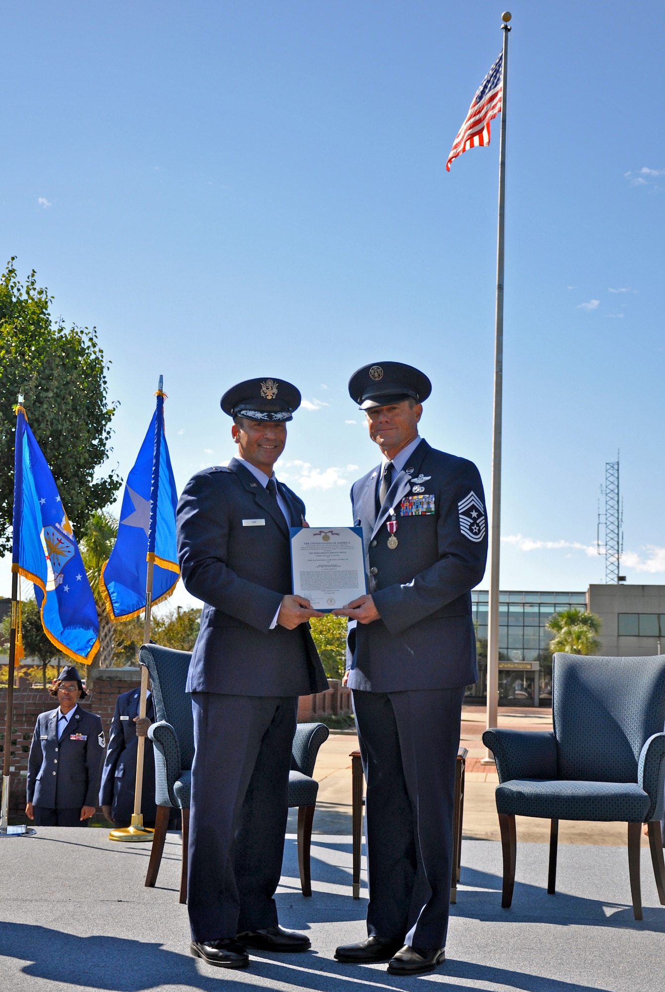 Brig. Gen. Michael D. Kim presents a Meritorious Service Medal, third oak leaf cluster, to Chief Master Sgt. Benson S. (Ben) Futrell during his retirement ceremony Oct. 3, 2010 at the Joint Base Charleston flagpole. General Kim is the mobilization assistant to the Director of Operations, Headquarters Air Mobility Command, Scott Air Force Base, Ill. Chief Futrell is retiring as the 315th Airlift Wing command chief master sergeant. (U.S. Air Force photo/Staff Sgt. Shane Ellis)