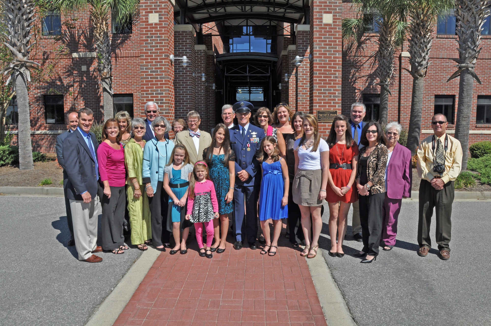 Chief Master Sgt. Benson S. (Ben) Futrell enjoys a photo opportunity with his family after his retirement ceremony Oct. 3, 2010 at the Joint Base Charleston Flagpole. Chief Futrell is retiring as the 315th Airlift Wing command chief master sergeant. (U.S. Air Force photo/Staff Sgt. Shane Ellis)