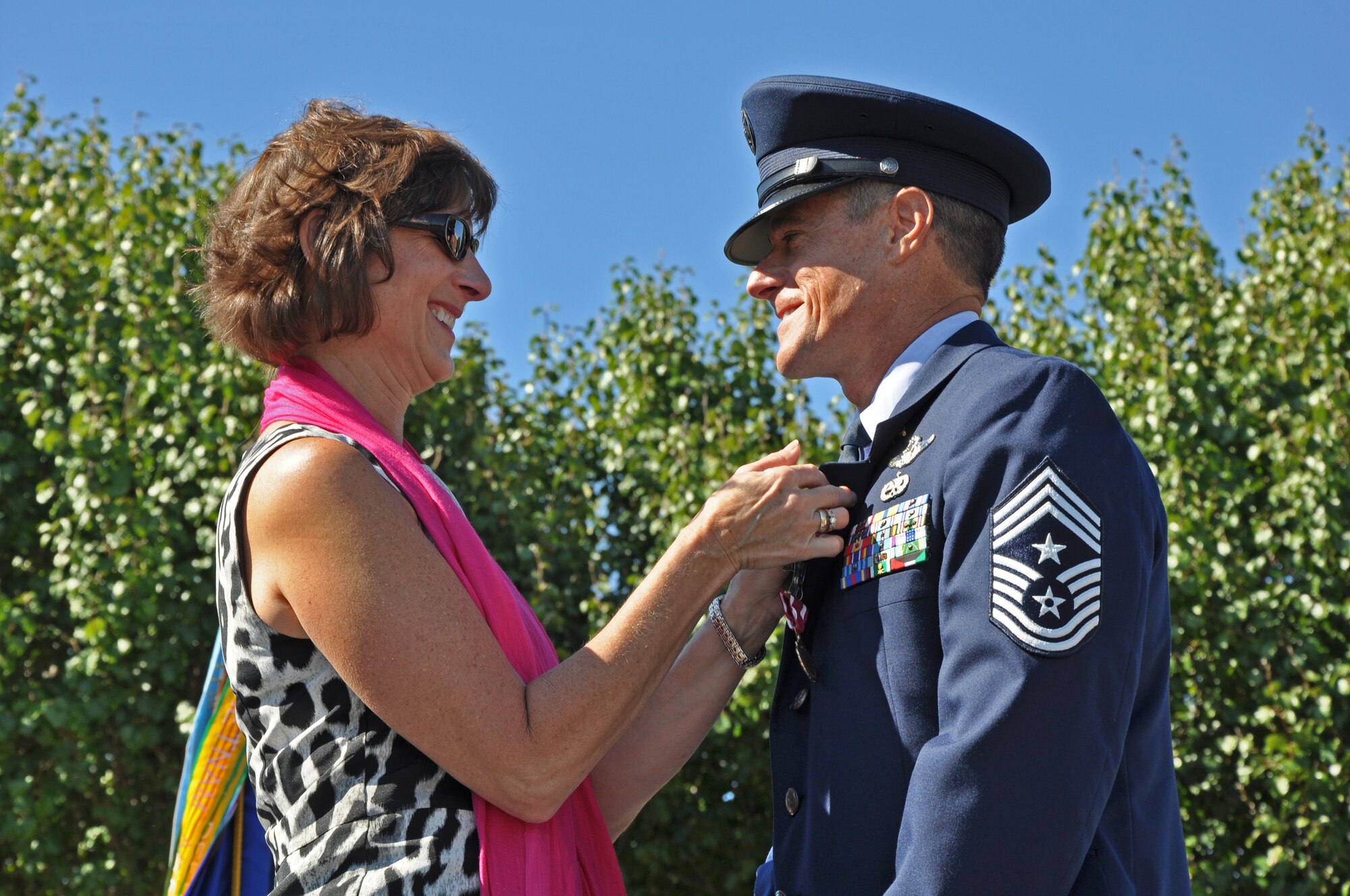 Chief Master Sgt. Benson S. (Ben) Futrell receives his retirement pin by his wife Addie Futrell Oct. 3, 2010 at the Joint Base Charleston Flagpole. Chief Futrell is retiring as the 315th Airlift Wing command chief master sergeant. (U.S. Air Force photo/Staff Sgt. Shane Ellis)