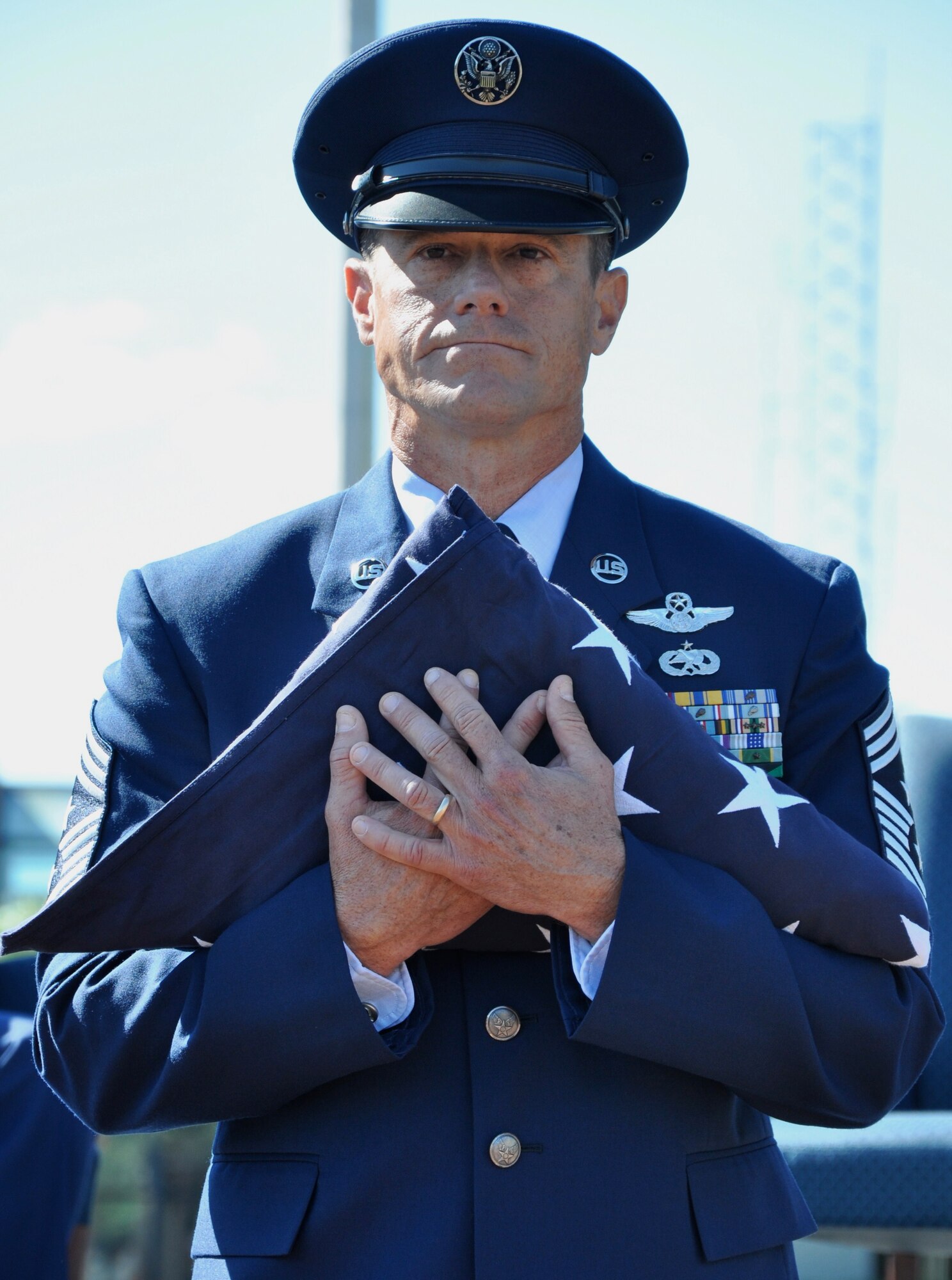 Chief Master Sgt. Benson S. (Ben) Futrell holds the American flag presented to him by the Joint Base Charleston Honor Guard during his retirement ceremony Oct. 3, 2010 at the JBC flagpole. Chief Futrell is retiring as the 315th Airlift Wing command chief master sergeant. (U.S. Air Force photo/Staff Sgt. Shane Ellis)