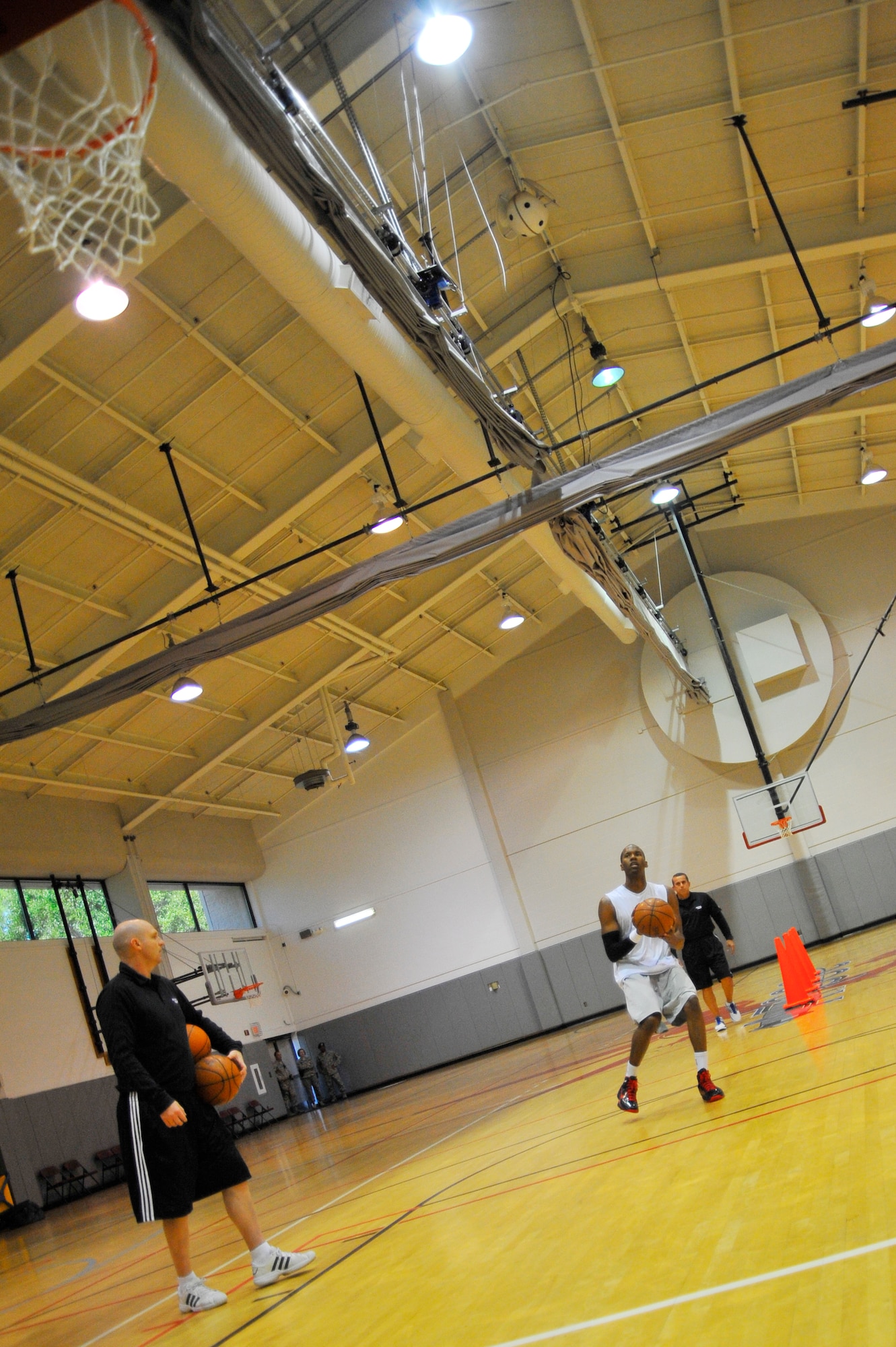 U.S. Air Force Capt. Antoine Hood, 919th Special Operations Wing, prepares to shoot a basket during a workout session with the Miami HEAT coaches at Hurlburt Field, Fla., Sept. 29, 2010. Captain Hood had a college basketball career at the Air Force Academy from 2002-2006.  (DoD photo by U.S. Air Force Senior Airman Sheila deVera/RELEASED)
