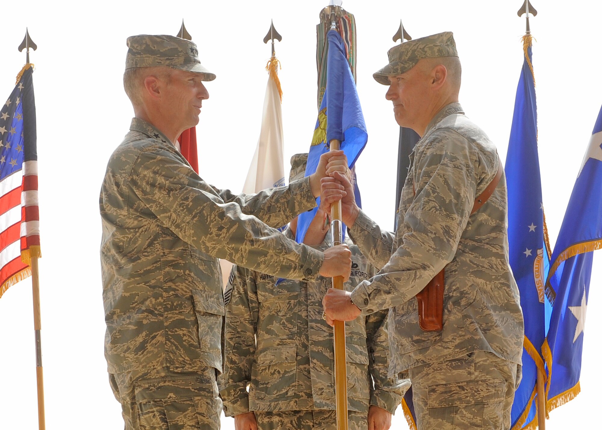 Lt. Gen. Mike Hostage, U.S. Air Forces Central Command commander,  presents the 332nd Air Expeditionary Wing guidon to Brig. Gen. Kurt Neubauer, 332nd AEW commander, during a change of command ceremony Oct. 5, 2010, Joint Base Balad, Iraq. General Neubauer assumed command of the Wing during the ceremony. (U.S. Air Force photo/ Senior Airman Matt Coleman-Foster)