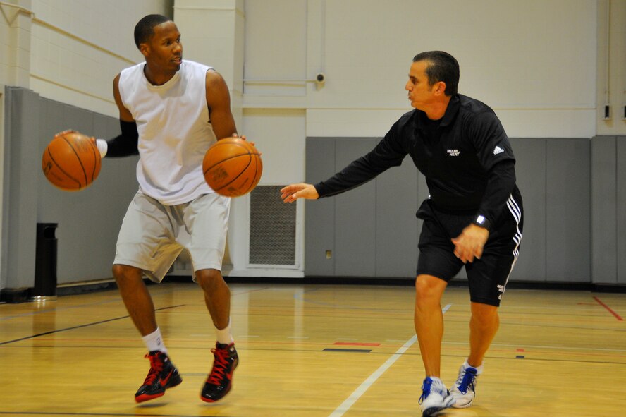 Octavio DeLagrana, Miami HEAT player development coach, watches U.S. Air Force Capt. Antoine Hood, 919th Special Operations Wing, work on his dribbling technique during a workout session at Hurlburt Field, Fla., Sept. 29, 2010. Captain Hood had a college basketball career at the Air Force Academy from 2002-2006.  (DoD photo by U.S. Air Force Senior Airman Sheila deVera/RELEASED)
