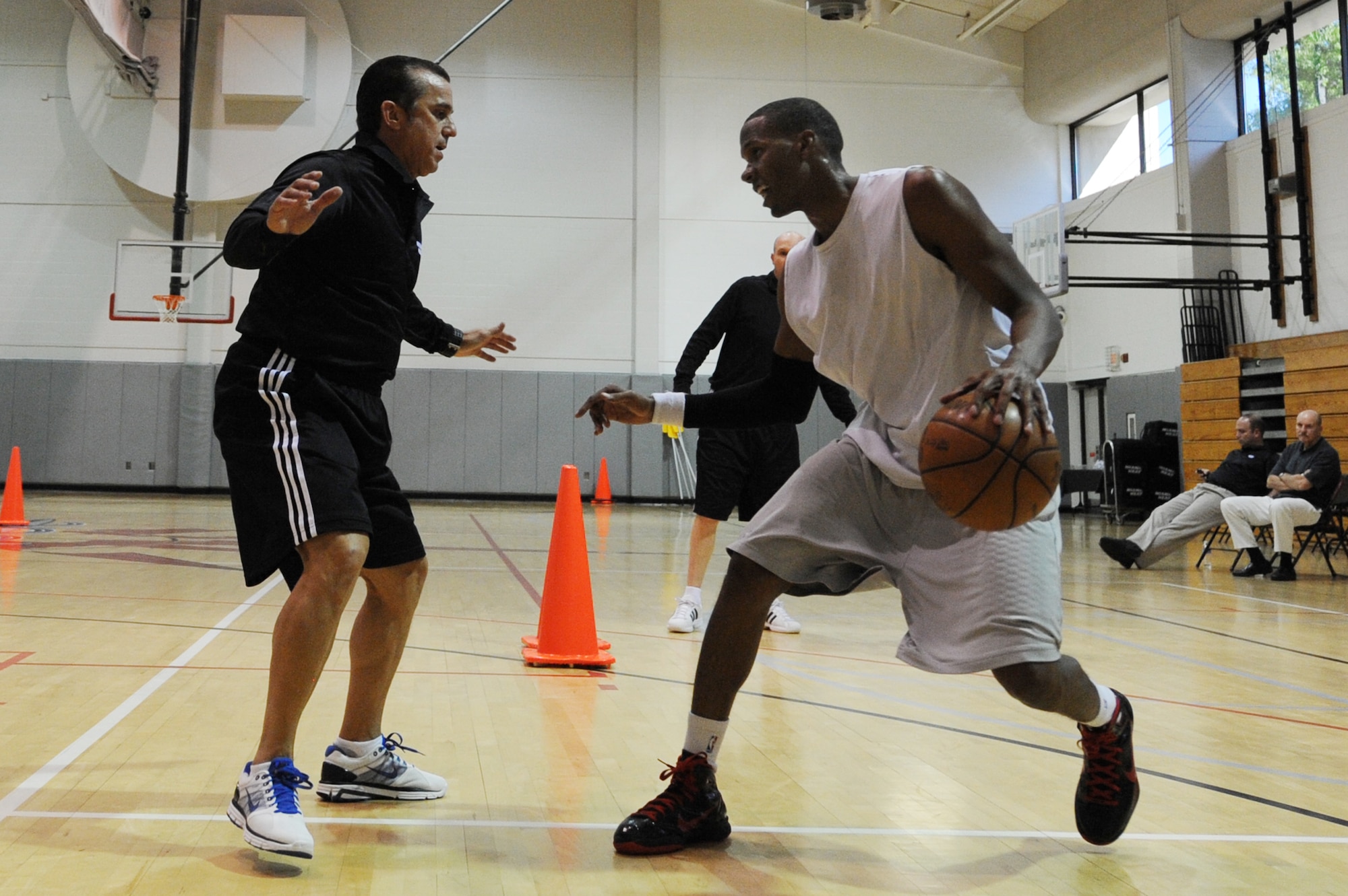U.S. Air Force Capt. Antoine Hood, 919th Special Operations Wing, does an offensive drill with Octavio DeLagrana, Miami HEAT player development coach, during a work-out session at Hurlburt Field, Fla., Sept. 29, 2010. Captain Hood had a college basketball career at the Air Force Academy from 2002-2006.  (DoD photo by U.S. Air Force Senior Airman Sheila deVera/RELEASED)
