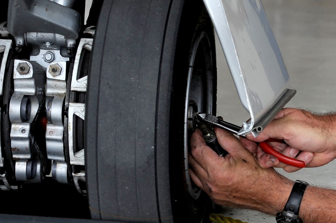 A worker checks landing gear on a C-21 during a phase inspection Sept. 15, 2010, at Scott Air Force Base, Ill. The phase inspections are done on aircraft after they reach flying milestones to ensure the aircraft remain in top condition. (U.S. Air Force photo/Staff Sgt. Brian J. Valencia)

