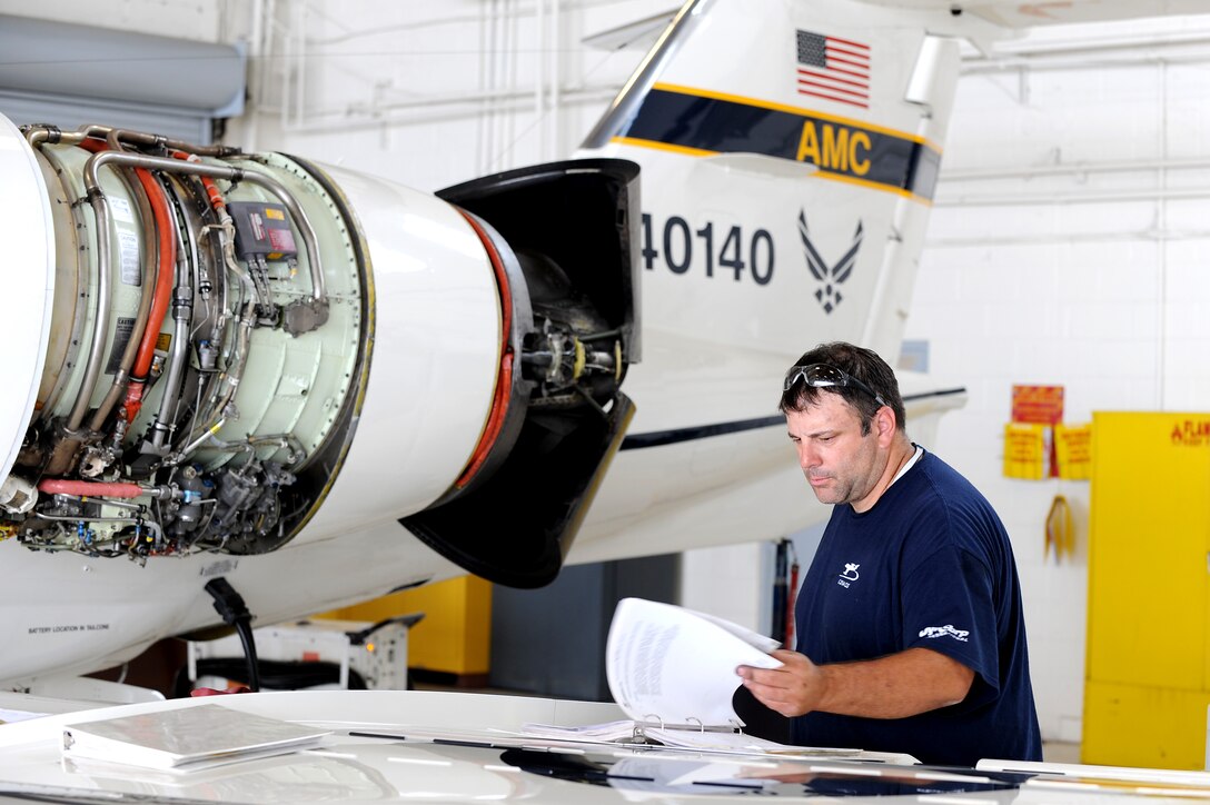 Eric Bollinger checks his technical orders while working on a C-21 during a phase inspection Sept. 15, 2010, at Scott Air Force Base, Ill.. Mr. Bollinger is a contractor with DynCorp International. (U.S. Air Force photo/Staff Sgt. Brian J. Valencia)