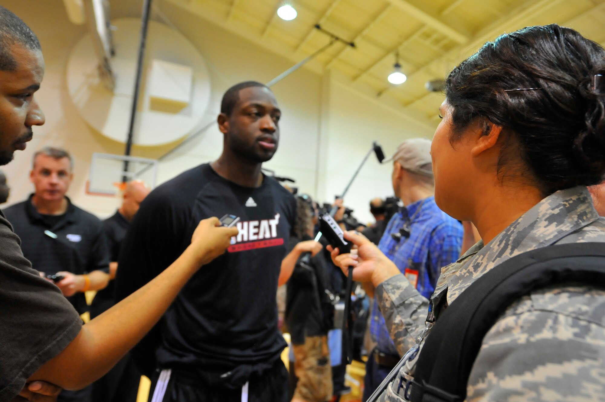 Dwyane Wade, Miami HEAT guard, answers questions from Staff Sgt. Sarah Martinez, 1st Special Operations Wing Public Affairs, after a practice session at the Aderholt Fitness Center at Hurlburt Field, Fla., Sept. 29, 2010. The team requested the use of the fitness center for their week-long training camp, and 1st Special Operations Wing leadership agreed to support the visit. (DoD photo by U.S. Air Force Senior Airman Sheila deVera/RELEASED)


