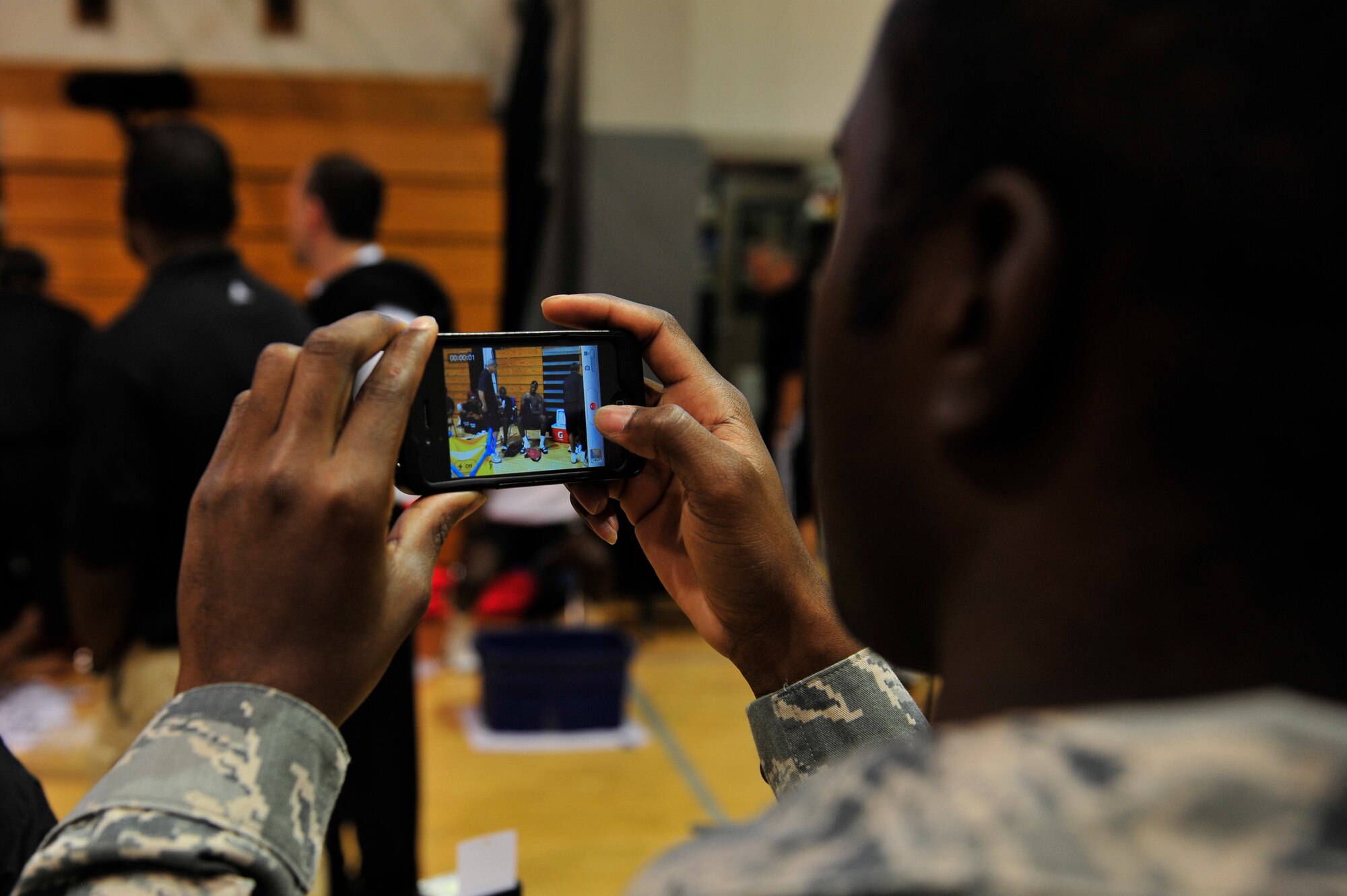 A Miami HEAT fan takes photos of the team cool down during the Miami HEAT 2010 Training Camp at the Aderholt Fitness Center, Hurlburt Field, Fla., Sept. 29, 2010. The team requested the use of the fitness center for their week-long training camp, and 1st Special Operations Wing leadership agreed to support the visit. (DoD photo by U.S. Air Force Staff Sgt. Stephanie Jacobs/RELEASED)
