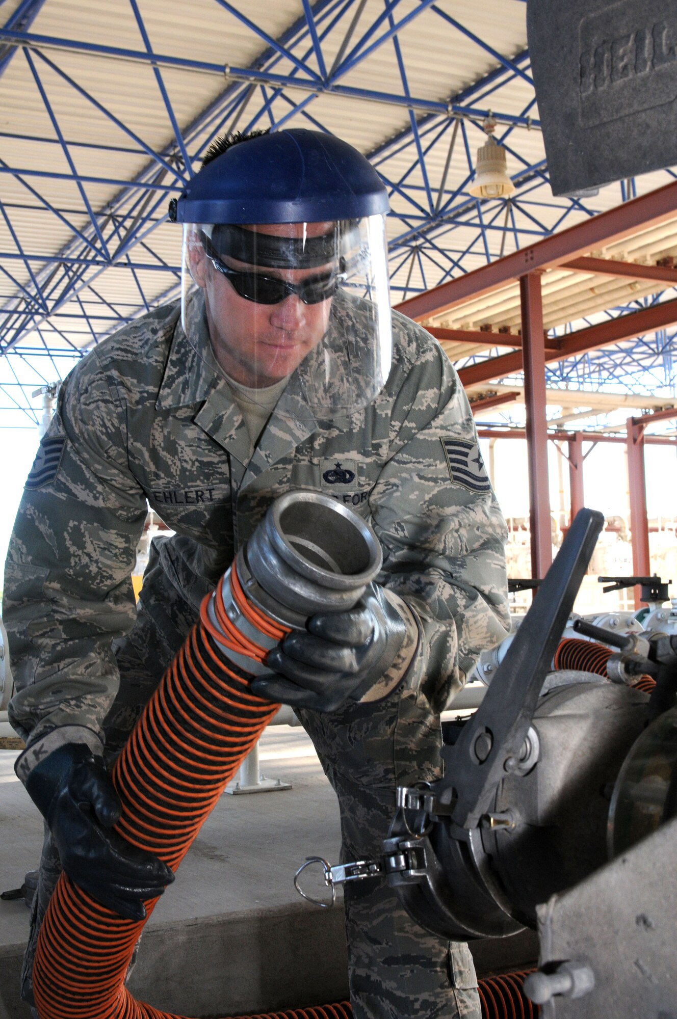 Tech. Sgt. Sean Ehlert, lab technician from the 162nd Fighter Wing, connects a receiver hose to a tanker truck’s discharge valve. The tankers each deliver 8,000-gallons of jet fuel that will be pumped into the base storage tanks and then reissued later that same morning to the wing’s fleet of F-16 Fighting Falcons. (Air Force photo by Staff Sgt. Jordan Jones)