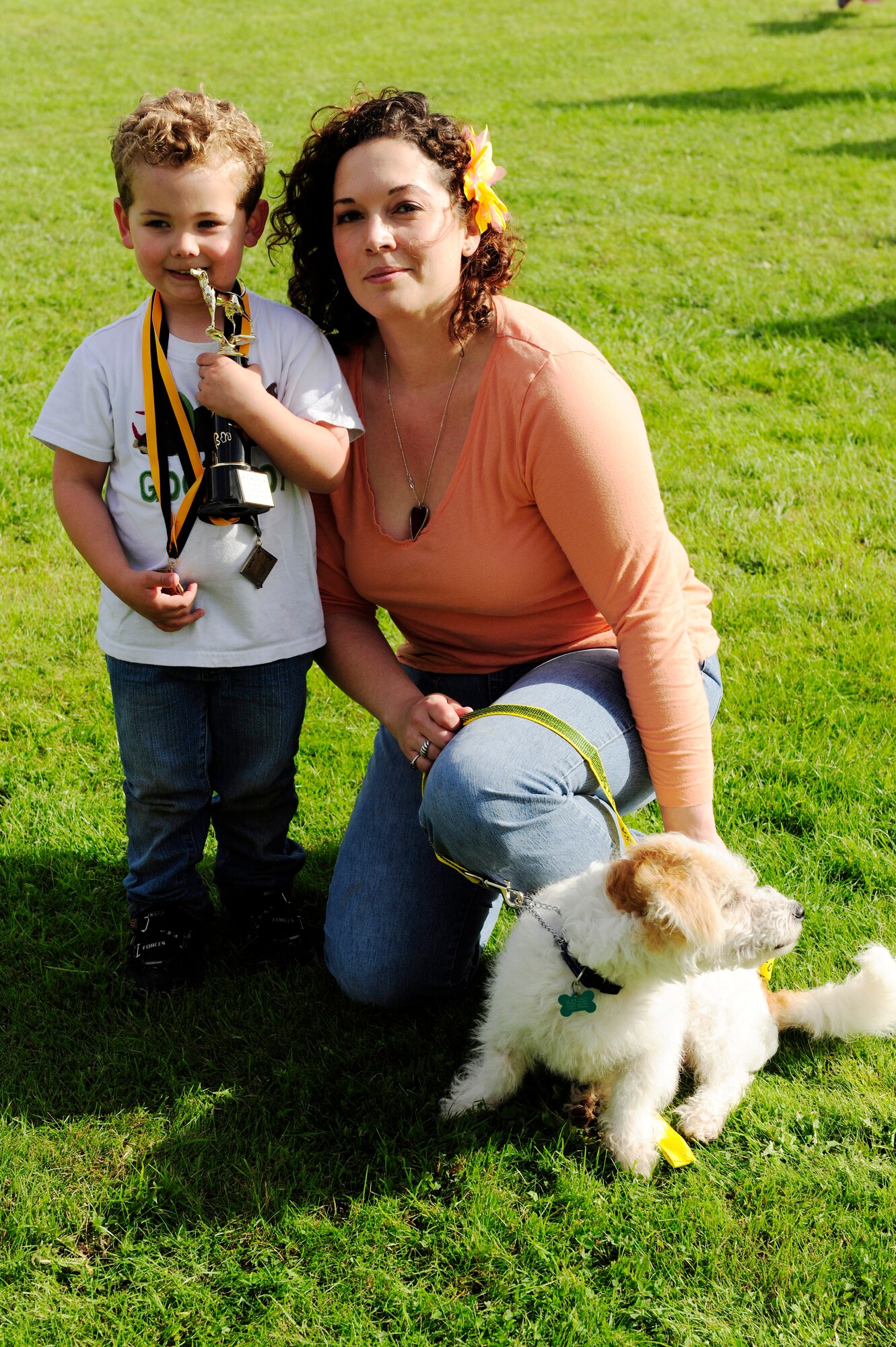 ROYAL AIR FORCE FELTWELL, England – Camden Melin (left), 3, and his mother, Deanna Melin, Pet Fest participant, hold two medals and a trophy won by their dog, Gizmo, during the third Annual Pet Fest, Oct. 2. Gizmo won first place for ‘best trick’, third for ‘best costume’ and third for ‘best pet and owner look-a-like’. The third Annual Pet Fest was hosted by the RAF Feltwell Veterinary Clinic. (U.S. Air Force photo/Airman 1st Class Lausanne Morgan)
