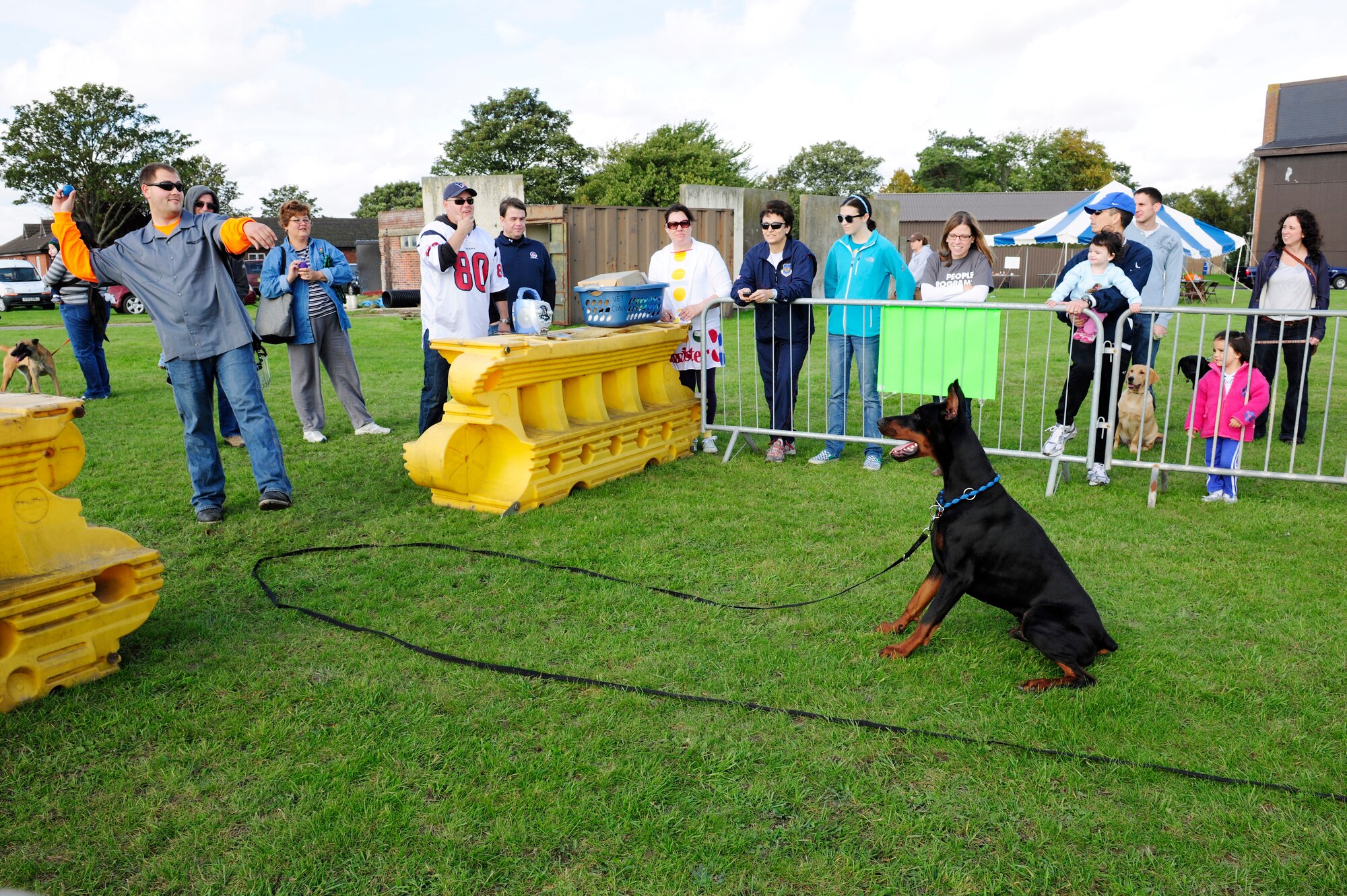ROYAL AIR FORCE FELTWELL, England – Staff Sgt. Brian Mass (left), 48th Civil Engineer Squadron fire fighter, prepares to throw a ball for his dog, Mars, to fetch Oct. 2. More than 50 Airmen and families from RAFs Lakenheath, Mildenhall and Feltwell were in attendance at the Third Annual Pet Fest hosted by the RAF Feltwell Veterinary Clinic. There were a total of four competitions to include: best pet tricks, pet and owner look-a-like, best costume and fastest fetch. (U.S. Air Force photo/Airman 1st Class Lausanne Morgan)