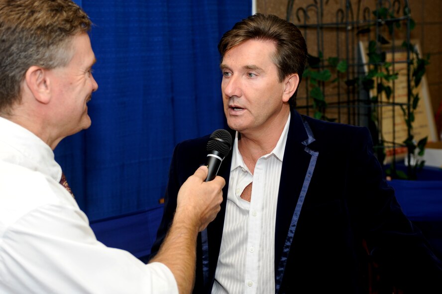 MINOT, N.D. -- Daniel O’Donnell, an Irish music artist, interviews with a local merchant at the Norsk Hostfest here Sept. 29. Celebrating its 33rd year in service to the Scandinavian culture, the festival provides a fun, family atmosphere for Air Force Global Strike Command Airmen to rest and relax among peers, friends and fellow community members. (U.S. Air Force photo by Senior Airman Benjamin Stratton)