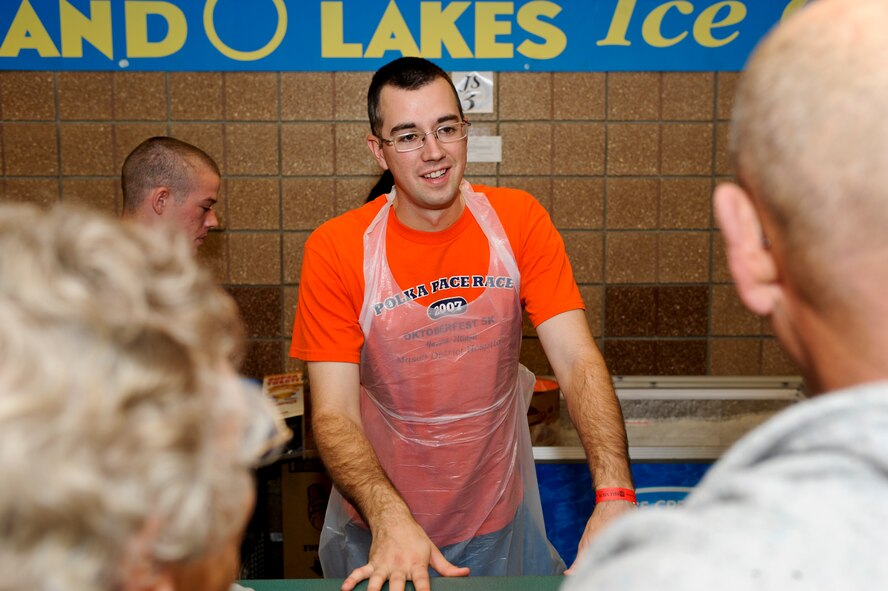 MINOT, N.D. -- Airman 1st Class Ryan Ferree, 5th Munitions Squadron munitions system apprentice, serves ice cream at the Norsk Hostfest here Sept. 29. Celebrating its 33rd year in service to the Scandinavian culture, the festival provides a fun, family atmosphere for Air Force Global Strike Command Airmen to rest and relax among peers, friends and fellow community members. (U.S. Air Force photo by Senior Airman Benjamin Stratton)