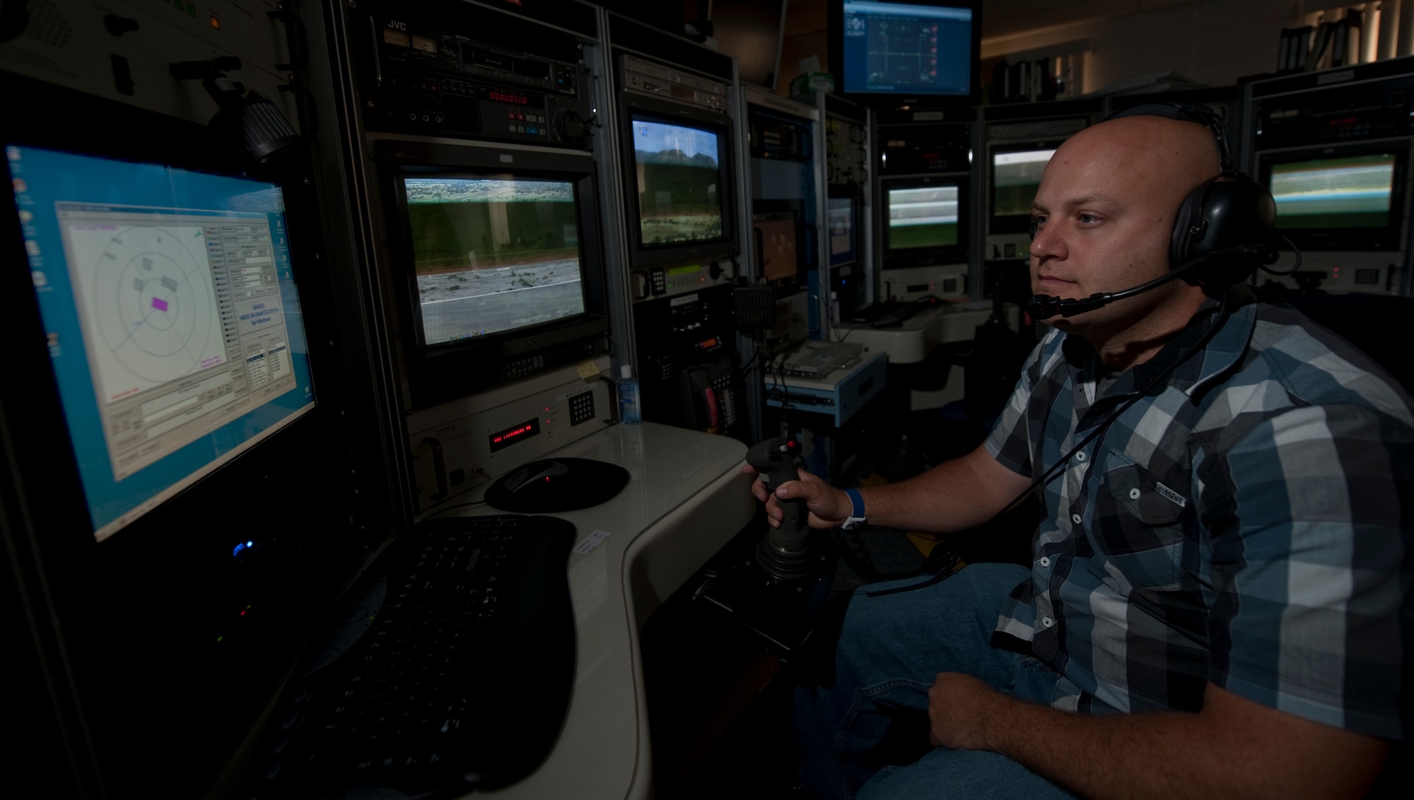 HOLLOMAN AIR FORCE BASE, N.M. -- Jason Champagne, 49th Operation Support Squadron, scores how accurately an MQ-9 Reaper hit a target on the Red Rio Range, Sept. 23, 2010. The 49th Operations Support Squadron's Range Operations Center is responsible for monitoring all training missions that take place on Holloman's three ranges; the Centennial Range, Oscura Bombing Range, and Red Rio Bombing Range. (U.S. Air Force photo by Airman 1st class Joshua Turner / Released)