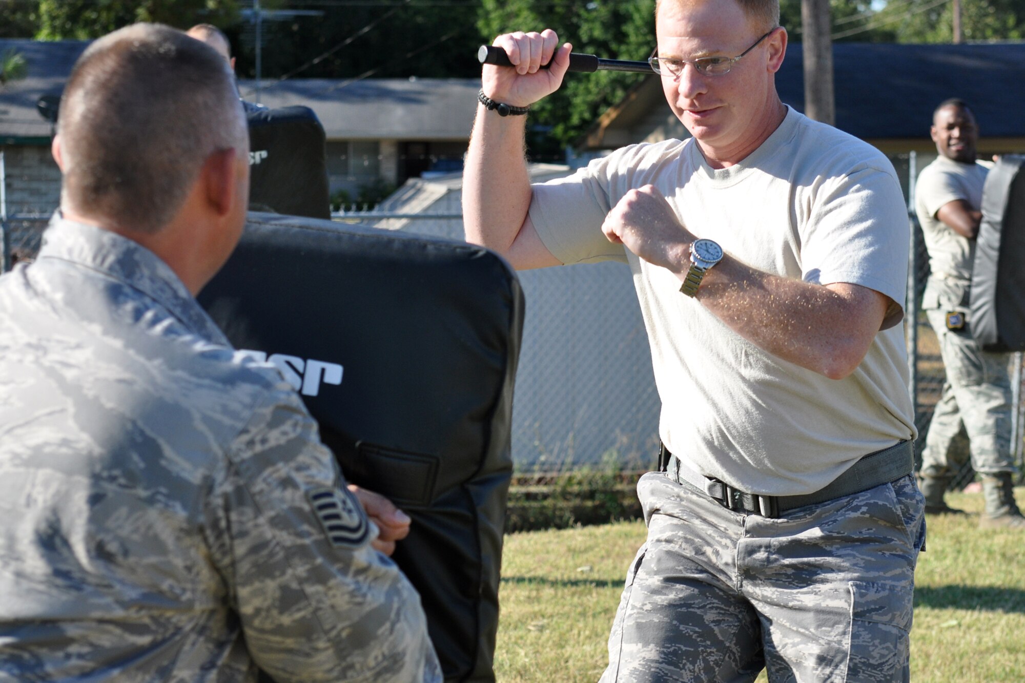 Senior Master Sgt. Charles Parker Jr., operations superintendent for the 917th Security Forces Squadron, prepares a weapon’s strike to a pad held by one of his fellow Airmen during an ASP Certification Training class outside the 917th SFS building at Barksdale Air Force Base, La., Oct. 3, 2010. The class was in the middle of its two-minute reaction drills, where the participant must engage eight different pads continuously for two minutes, with constantly changing strike commands from the instructor. The evolution is designed to wear a participant down, thus building endurance. (U.S. Air Force photo/Tech. Sgt. Jeff Walston)

