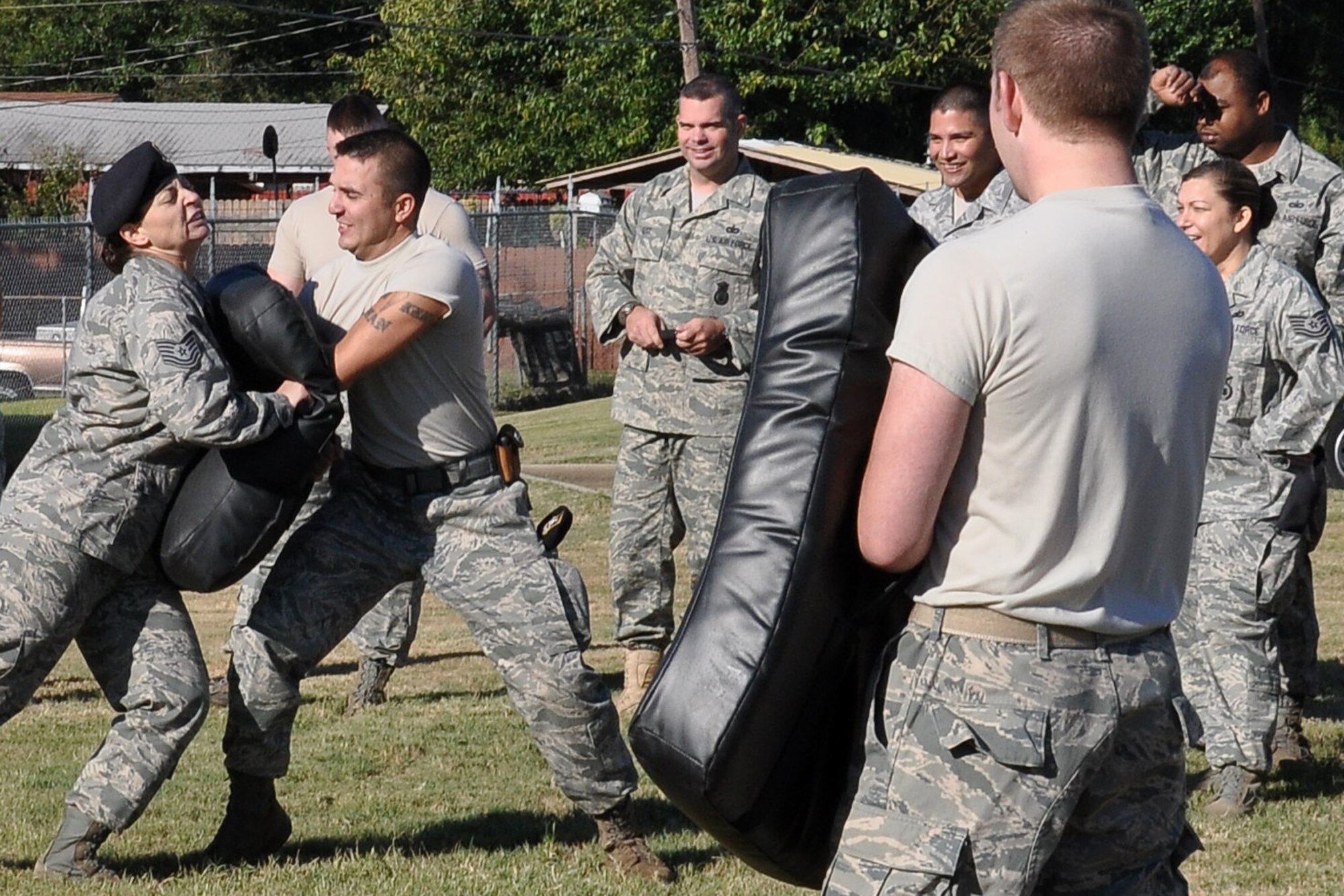 Technical Sgt. Andrea Pepper, a security forces craftsman with the 917th Security Forces Squadron, compares upper body strength with a center strike to the pad of fellow security forces member Staff Sgt. Jeremy Uptall, during an ASP Certification Training class outside the 917th SFS building at Barksdale Air Force Base, La., Oct. 3, 2010. Sergeant Uptall is a security forces journeyman with the 917th SFS. The class was in the middle of its two-minute reaction drills, where the participant must engage eight different pads continuously for two minutes, with constantly changing strike commands from the instructor. The evolution is designed to wear a participant down, thus building endurance. (U.S. Air Force photo/Tech. Sgt. Jeff Walston)