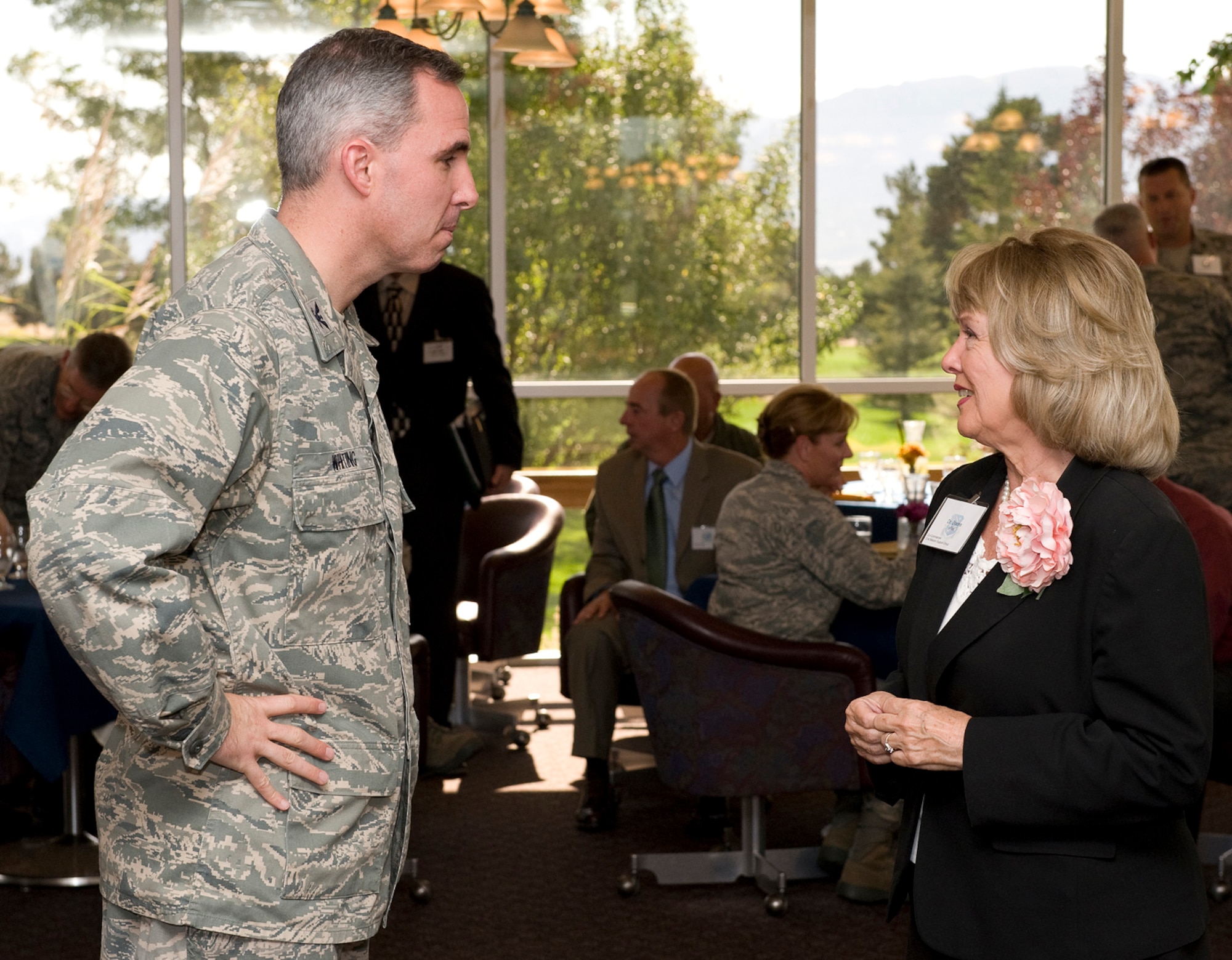 PETERSON AIR FORCE BASE, Colo. – Col. Stephen N. Whiting, 21st Space Wing commander, speaks to Dr. Pat Boone, a Colorado Springs civic leader, during the 21st SW Co-Commander Program icebreaker Sept. 21 at the Peterson Golf Course. The Air Force launched the Co-Commander Program as a way for Air Force leaders to share the local Air Force mission with civic leaders, foster community partnerships, and increase 21st SW leadership involvement with the community. Colonel Whiting partnered two co-commanders with each group commander, who will invite their civilian counterparts to group events throughout the year. (U.S. Air Force photo/Craig Denton) 
