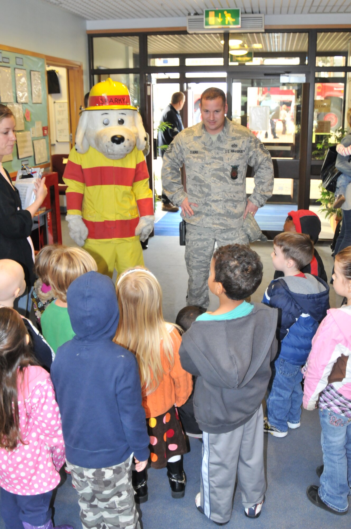 ROYAL AIR FORCE LAKENHEATH, England -- Tech. Sgt. Nathan Elkins of the 48th Fighter Wing Fire Prevention Office and Sparky the Firedog speak to children about fire safety at the Child Development Center West on Oct. 5. As part of Fire Prevention Week, the children were given the chance to have their picture taken with Sparky and tour a fire truck. (U.S. Air Force photo/Senior Airman David Dobrydney)