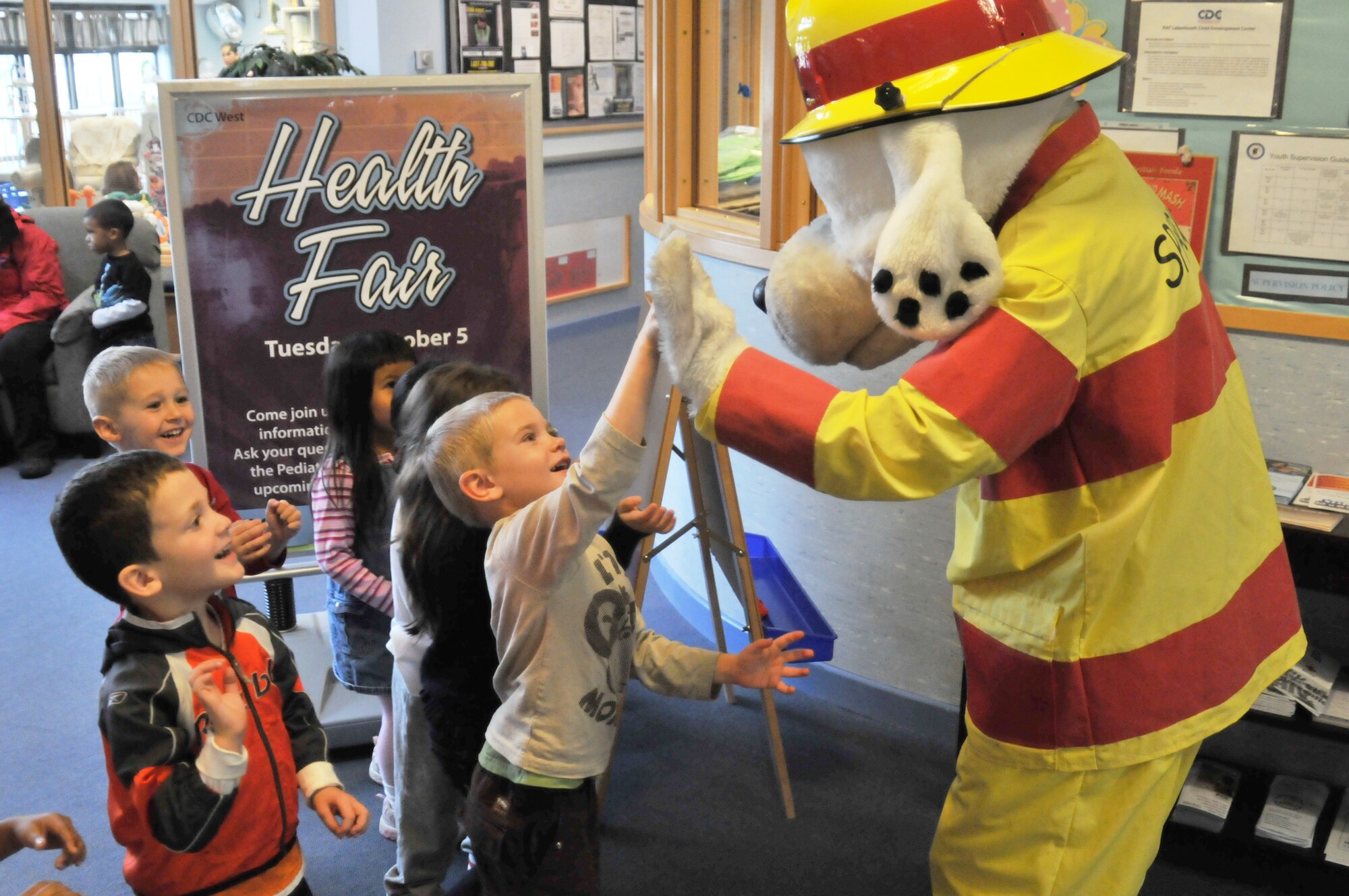 ROYAL AIR FORCE LAKENHEATH, England -- Children greet Sparky the Firedog at the Child Development Center West on Oct. 5 as part of Fire Prevention Week. The children learned about fire safety and were given the chance to tour a fire truck. (U.S. Air Force photo/Senior Airman David Dobrydney)