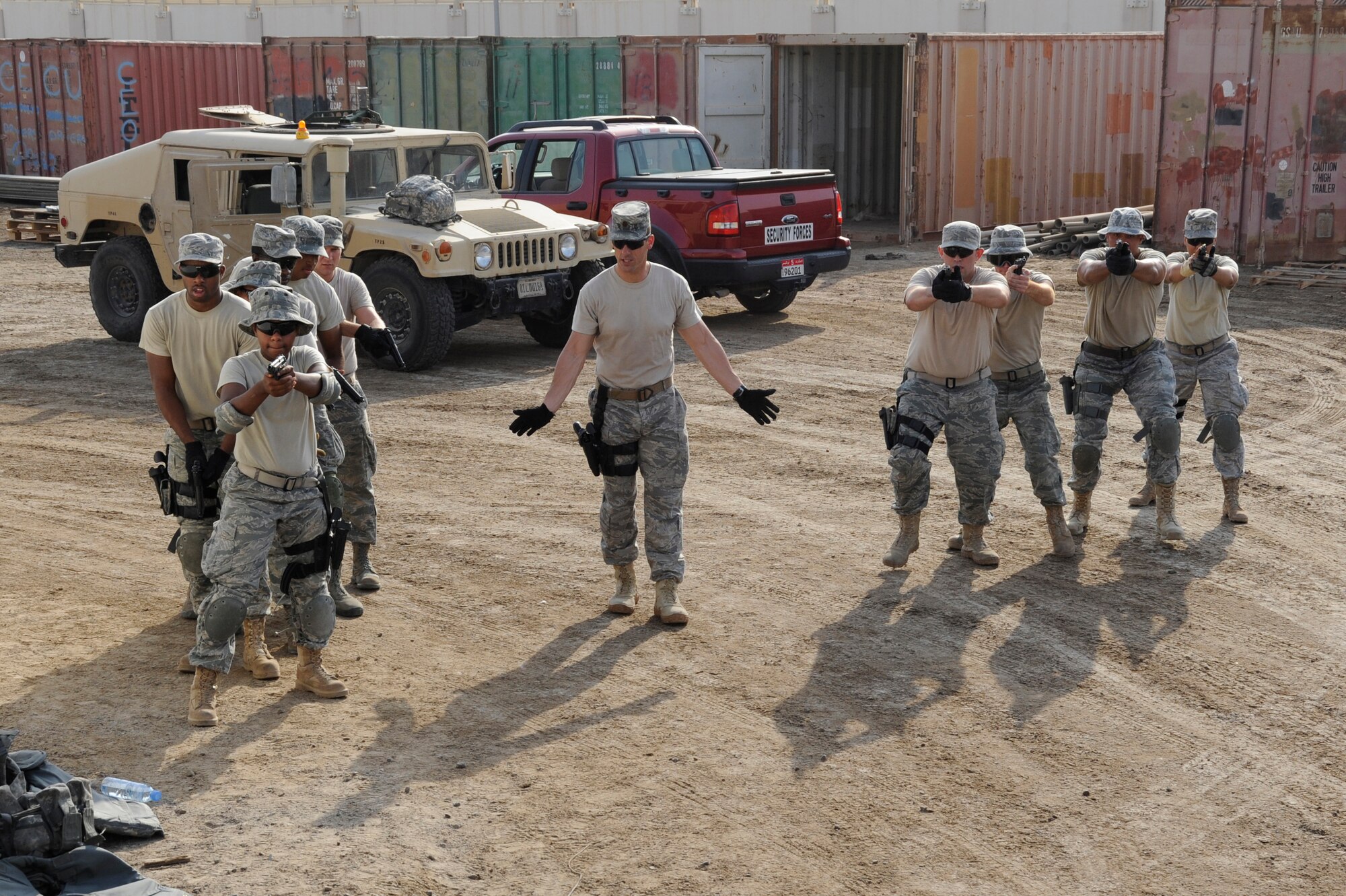 (Center) Maj. Damian Schlussel, 380th Expeditionary Security Forces Squadron commander, directs a group of Security Forces Airmen during vehicle assault training Sept. 28, 2010, at an undisclosed location in Southwest Asia. Vehicle assault training is part of a combat readiness course for security forces Airmen that was designed to help retain skill proficiencies, build team work and prepare personnel to react to a variety of situations. (U.S. Air Force photo/Tech. Sgt. April Wickes)