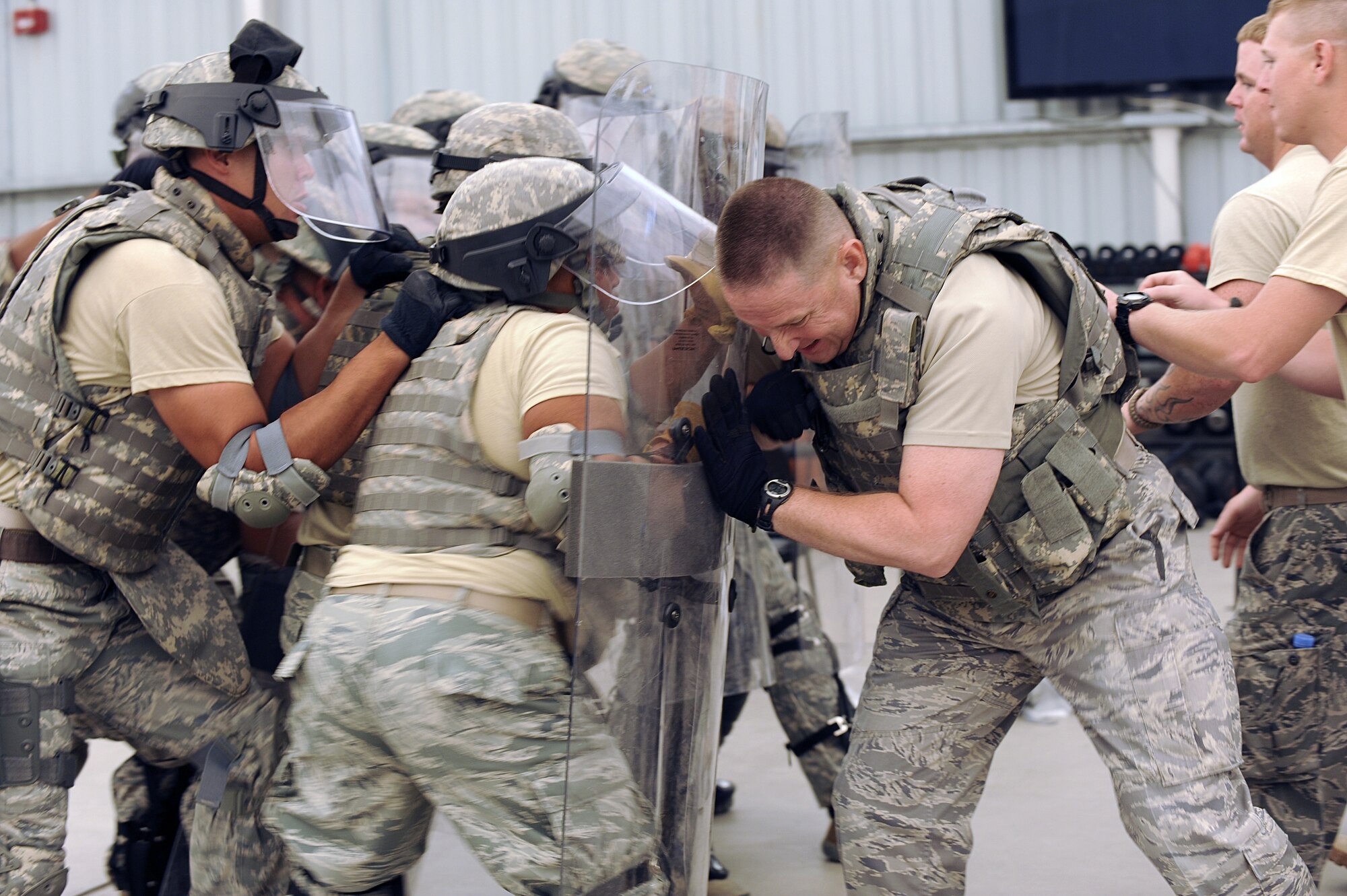 (Center)Tech. Sgt. Alex Bell, 380th Expeditionary Security Forces Squadron combat readiness course cadre, and other 380th SFS cadres pose as riot members as students try to suppress them during riot control training Sept. 28, 2010, at an undisclosed location in Southwest Asia. Riot control training is part of a combat readiness course for security forces Airmen that was designed to help retain skill proficiencies, build team work and prepare personnel to react to a variety of situations. (U.S. Air Force photo/Tech. Sgt. April Wickes)