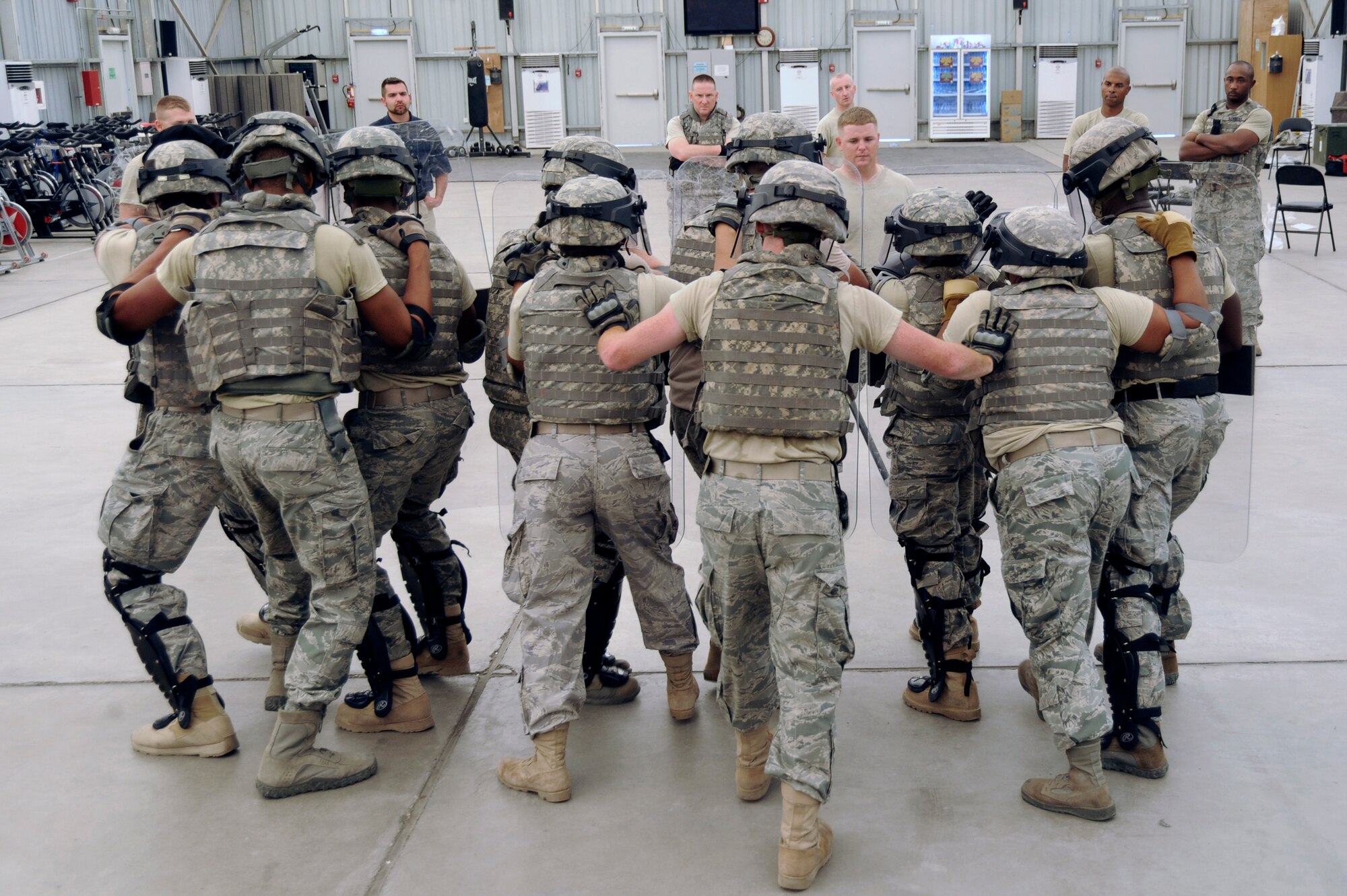 Airmen from the 380th Expeditionary Security Forces Squadron work together as a team during riot control training Sept. 28, 2010, at an undisclosed location in Southwest Asia. Riot control training is part of a combat readiness course for security forces Airmen that was designed to help retain skill proficiencies, build team work and prepare personnel to react to a variety of situations. (U.S. Air Force photo/Tech. Sgt. April Wickes)