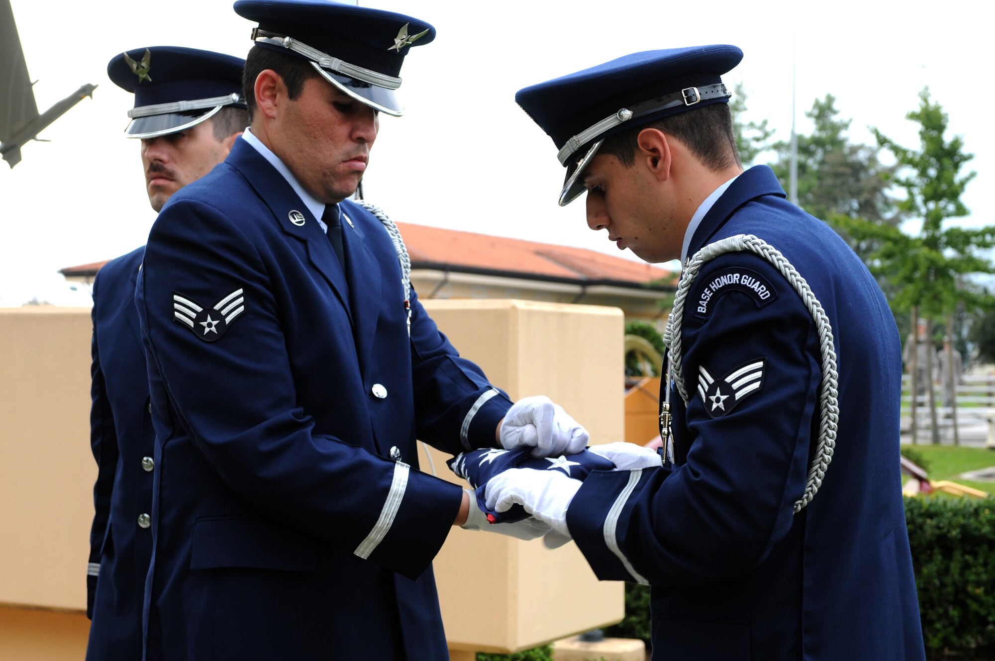 Aviano Honor Guard members fold the flag during the POW/MIA Week commemoration at the 31st Fighter Wing Headquarters Sept. 30. The Air Force Sergeants Association hosted activities to commemorate the POW/MIA Week. (U.S. Air Force photo/Staff Sgt. Julius Delos Reyes)