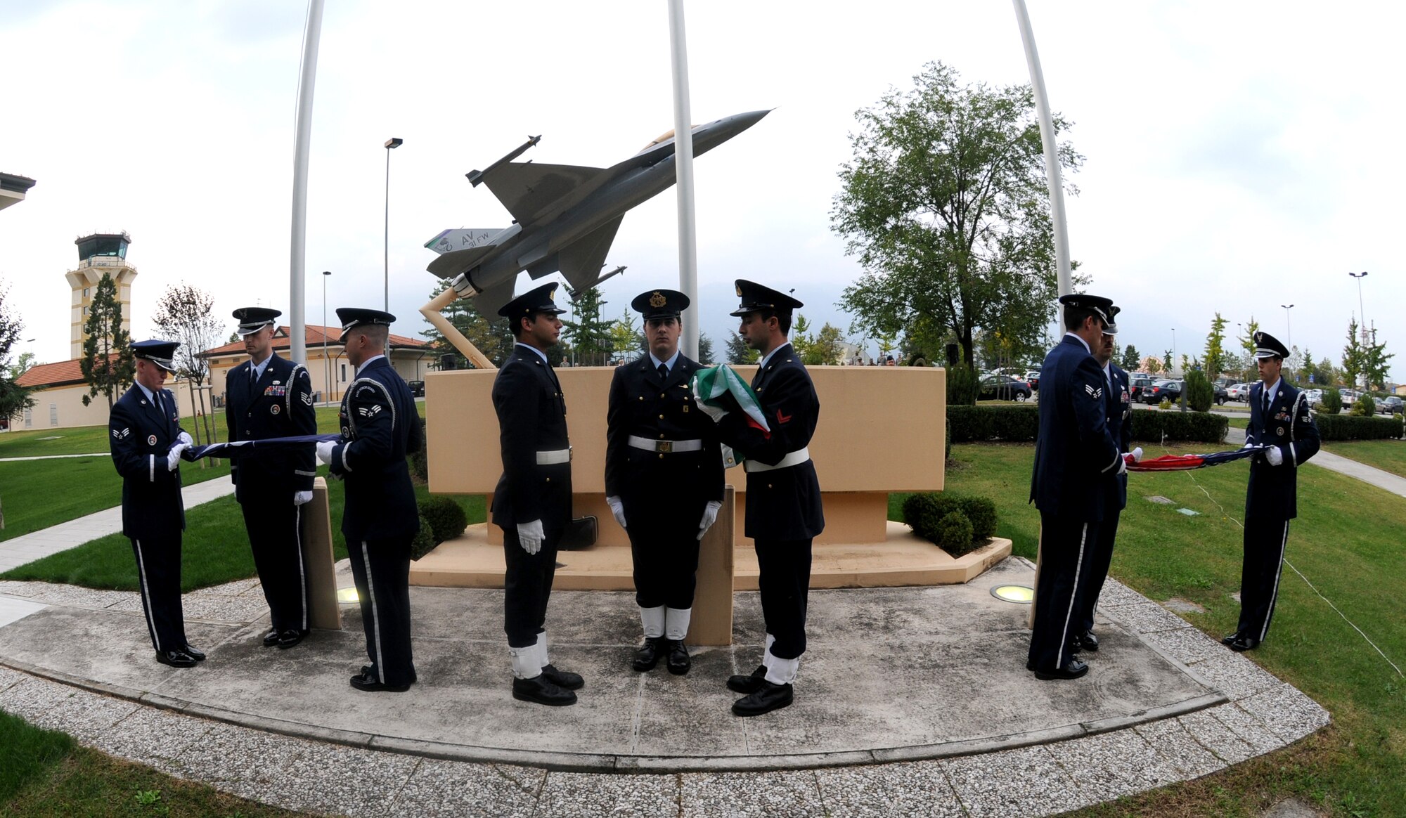 Aviano Honor Guard members and Italian air force personnel fold the flags during a POW/MIA Week commemoration ceremony at the 31st Fighter Wing Headquarters Sept. 30. (U.S. Air Force photo/Staff Sgt. Julius Delos Reyes)