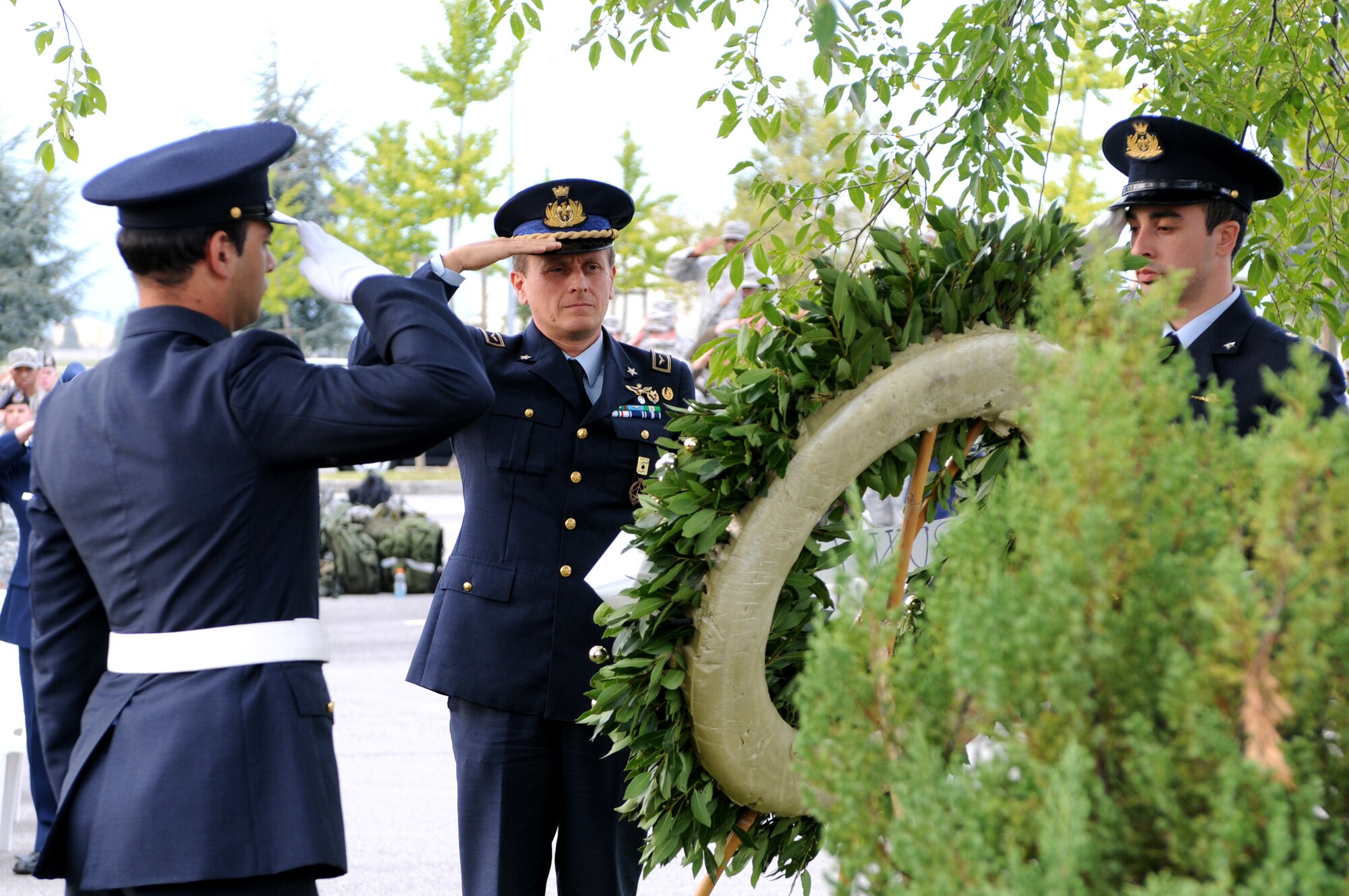 Italian air force Col. Luca Cappelli, Pagliano e Gori Airport commander, and ITAF honor guards salute after placing a wreath during the POW/MIA ceremony Sept. 30 at the 31st Fighter Wing Headquarters building. The Air Force Sergeants Association hosted the POW/MIA Week commemoration from Sept. 27 through 30. (U.S. Air Force photo/Staff Sgt. Julius Delos Reyes)