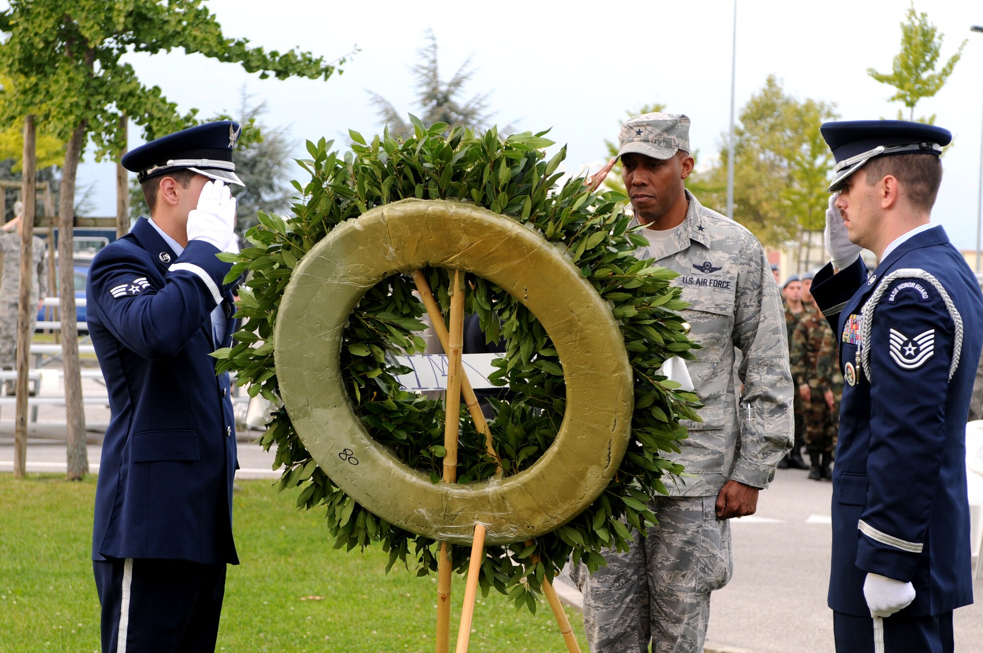 Brig. Gen. C. Q. Brown Jr. 31st Fighter Wing commander, and Aviano Honor Guard members render a salute during a POW/MIA commemoration ceremony at the 31st FW Headquarters Sept. 30. (U.S. Air Force photo/Staff Sgt. Julius Delos Reyes)