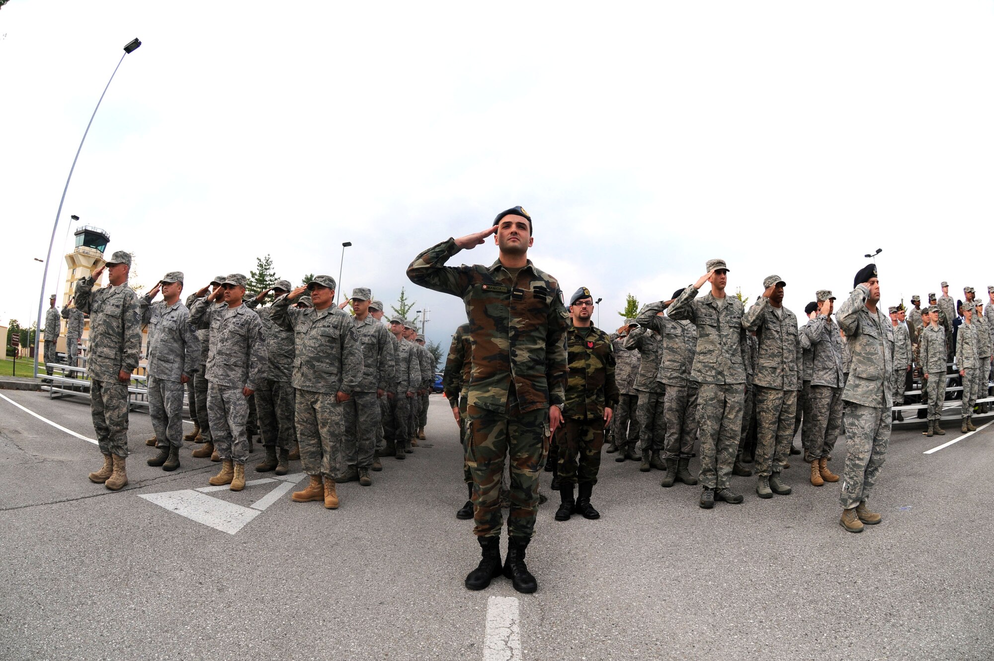 Airmen with the 31st Fighter Wing and Italian air force render their salute during a POW/MIA Week ceremony at the 31st FW Headquarters Sept. 30. The week is in honor of prisoners of war and those missing in action. (U.S. Air Force photo/Staff Sgt. Julius Delos Reyes)