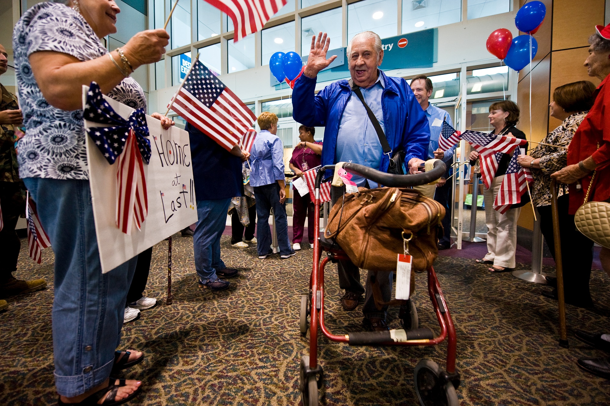 About 110 displaced residents of Armed Forces Retirement Home in Gulfport, Miss., arrive to a hero's welcome at the airport Oct. 4, 2010, from Washington D.C. Nearly 150 veterans returned home to south Mississippi after being forced to evacuate five years ago after Hurricane Katrina. (U.S. Air Force photo/Tech. Sgt. Bennie J. Davis III)