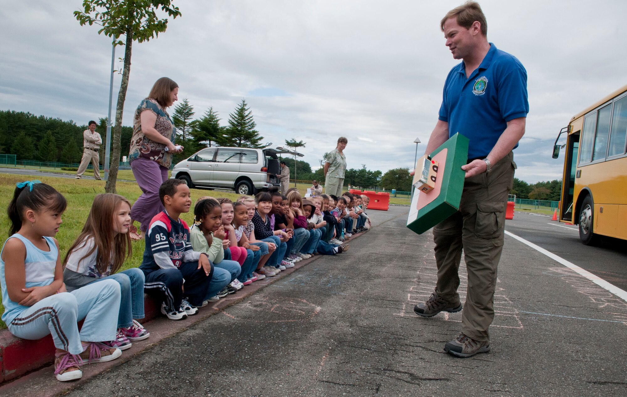 Chris Zeitvogel, Misawa Department of Defense schools’ student transportation manager, educates Cummings Elementary School first graders about school bus danger zones Sept. 28, 2010, at Misawa Air Base, Japan.  Mr. Zeitvogel taught preschoolers through sixth grade and their teachers at both Cummings and Sollars Elementary Schools on the importance of school bus safety. (U.S. Air Force photo by Senior Airman Jessica Lockoski/Released)