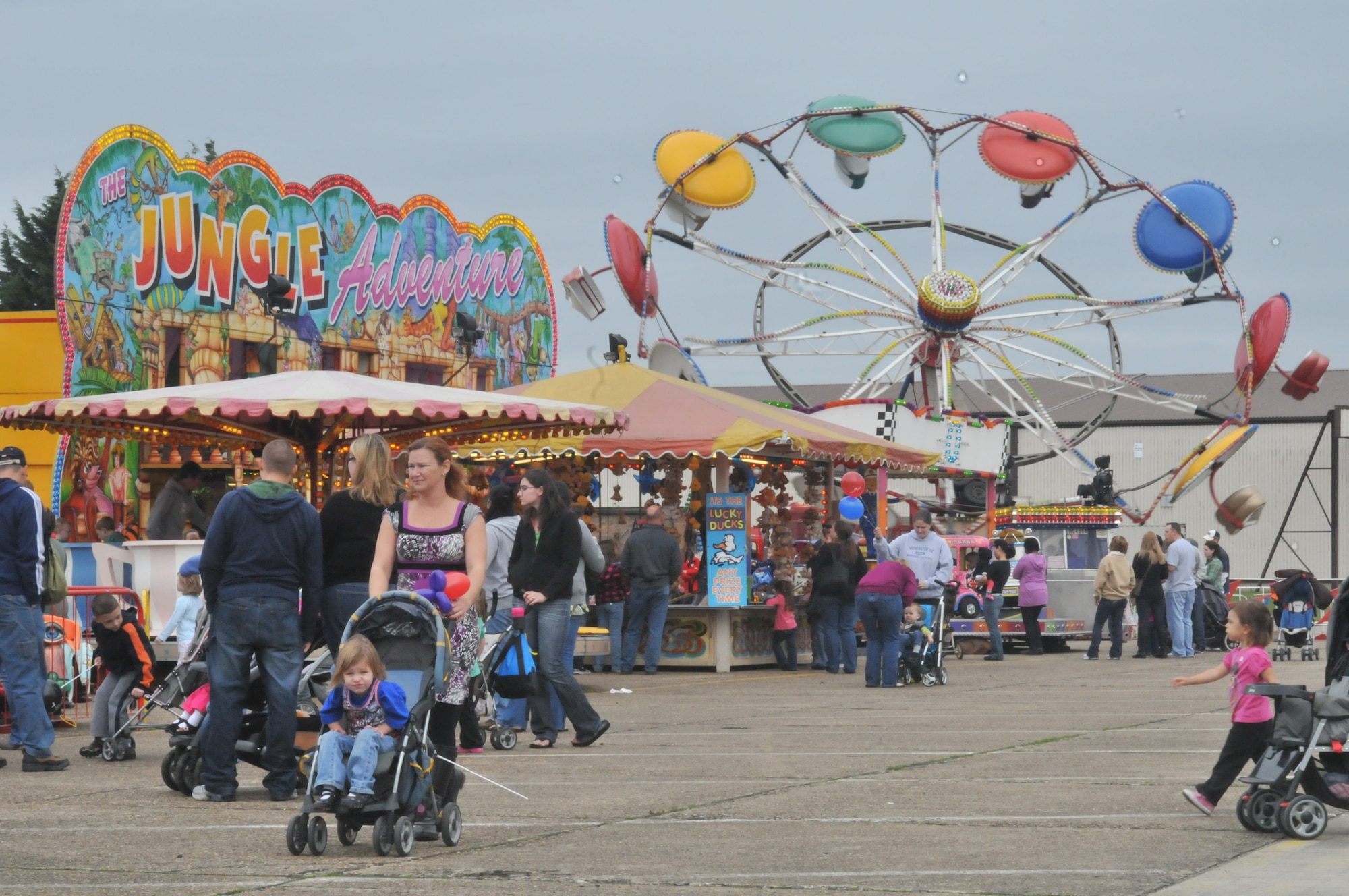 ROYAL AIR FORCE LAKENHEATH, England – Parents and children enjoy the carnival rides at the Holiday Bazaar on Oct. 2. Approximately 1,000 people came to shop the wares of more than 100 vendors from the local community. (U.S. Air Force photo/Senior Airman David Dobrydney)