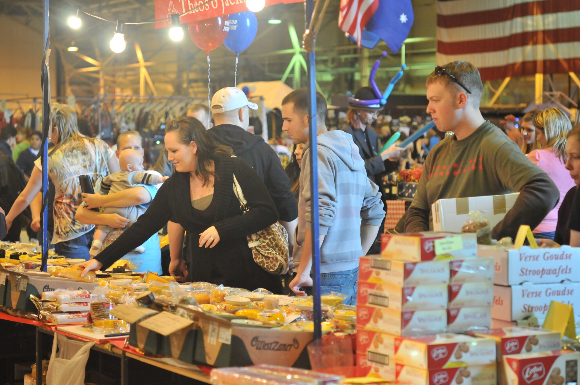 ROYAL AIR FORCE LAKENHEATH, England - Customers line up to do their Christmas shopping at one of the more than 100 vendors booths at the Holiday Bazaar on Oct. 2 in Hangar 7. The bazaar was sponsored by the Officers and Civilians Spouses Club and the Enlisted and Civilian Spouses club. (U.S. Air Force photo/Senior Airman David Dobrydney)