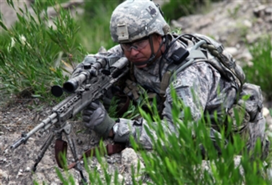 U.S. Army Command Sgt. Maj. Chris Field provides security with an M14 Enhanced Battle Rifle in Dewagal Valley, Chawkay district, Kunar province, Afghanistan, on Sept. 26, 2010.  