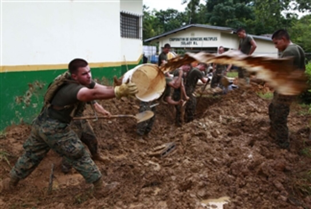 U.S. Marine Corps engineers with 8th Engineer Support Battalion and attached to the logistics combat element of Special-Purpose Marine Air-Ground Task Force Continuing Promise 2010 dig a drainage pit at an engineering site in Silico Creek, Panama, on Oct. 1, 2010.  Continuing Promise is a humanitarian and civic assistance mission with the goal of providing medical, dental, veterinary and engineering assistance to eight different nations.  