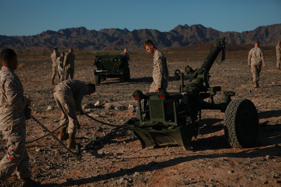 Marines with Combat Logistics Regiment 27 rig the Corps’ newest artillery weapon, the M-327 mortar component of the Expeditionary Fire Support System, in order for it to be airlifted by for the first time by a CH-53 helicopter in the Chocolate Mountain Aerial Gunnery Range on Oct. 5, 2010. The system, which is smaller and more mobile than a traditional howitzer cannon but more lethal than traditional man-carried mortars, consists of the 120 mm cannon, as well as a small vehicle and an ammunition trailer. Since the system is meant to be carried around the battlefield by helicopter, its deployment was tested as part of Weapons and Tactics Instructor course. The course, hosted twice a year at the Marine Corps Air Station in Yuma, Ariz., by Marine Aviation and Weapons Tactics Squadron 1, trains Marine students from across the globe to return to their units as training officers versed in the latest aviation tactics and procedures.