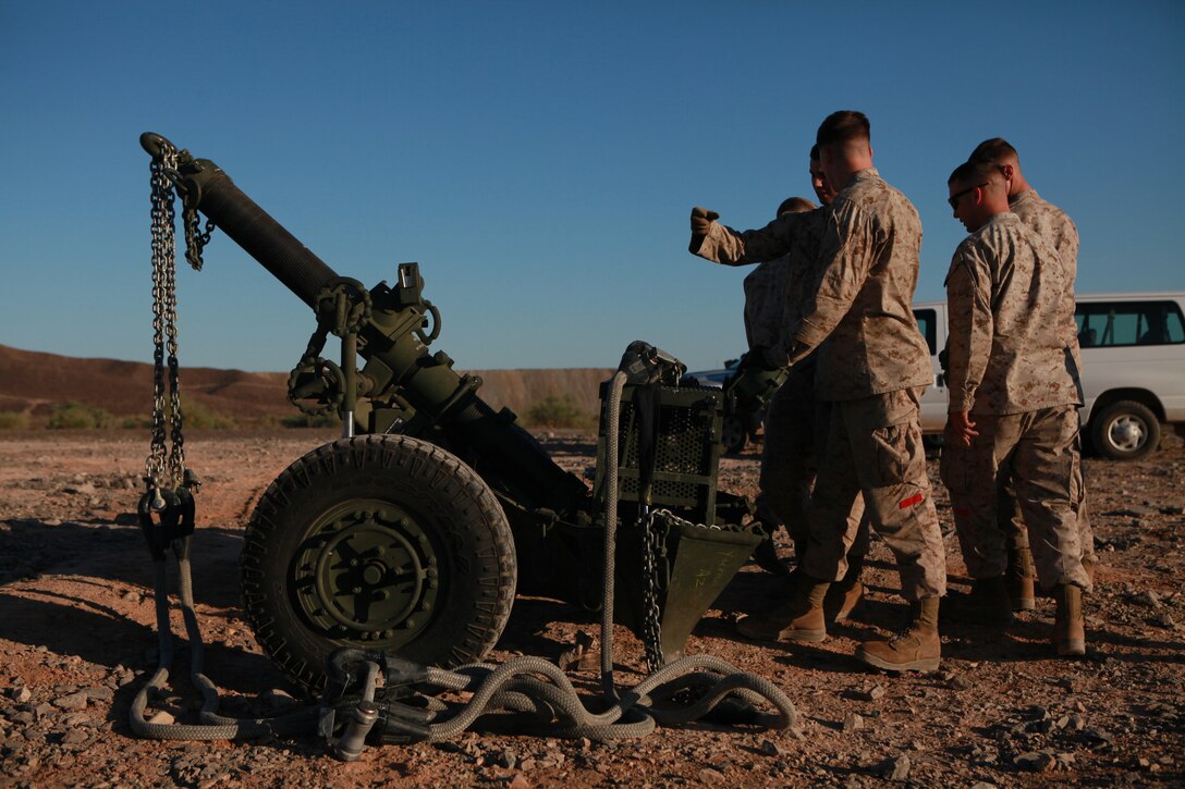 Marines with Combat Logistics Regiment 27 rig the Corps’ newest artillery weapon, the M-327 mortar component of the Expeditionary Fire Support System, in order for it to be airlifted by for the first time by a CH-53 helicopter in the Chocolate Mountain Aerial Gunnery Range on Oct. 5, 2010. The system, which is smaller and more mobile than a traditional howitzer cannon but more lethal than traditional man-carried mortars, consists of the 120 mm cannon, as well as a small vehicle and an ammunition trailer. Since the system is meant to be carried around the battlefield by helicopter, its deployment was tested as part of Weapons and Tactics Instructor course. The course, hosted twice a year at the Marine Corps Air Station in Yuma, Ariz., by Marine Aviation and Weapons Tactics Squadron 1, trains Marine students from across the globe to return to their units as training officers versed in the latest aviation tactics and procedures.