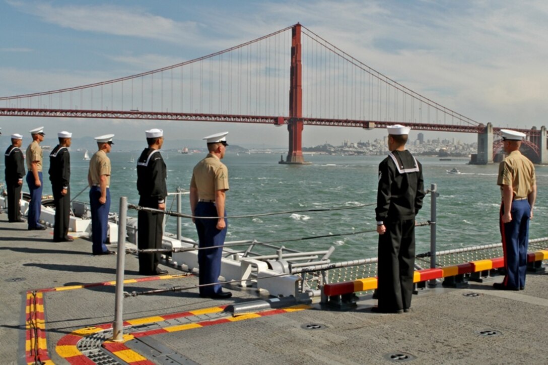 Marines and sailors man USS Makin Island's rails as the amphibious assault ship sails into San Francisco Bay, Oct. 6, 2010. The Marines are part of the 11th Marine Expeditionary Unit's special-purpose Marine air-ground task force, which is the first amphibious landing force to embark Makin Island. The ship left San Diego, Oct. 1, to participate in San Francisco's 2010 Fleet Week. The unit will showcase to the public the Marine Corps' men and women, its aircraft and equipment, and its ability to conduct missions that span the overlapping spectrums of peace and combat, from disaster relief to war.