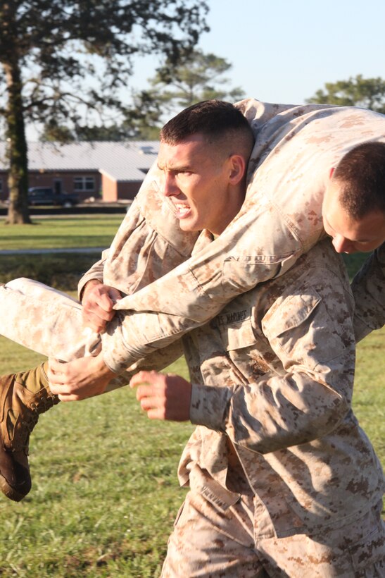 Cpl. Eric T. Petry, an aviation precision measurement equipment technician with Marine Aviation Logistics Squadron 14, carries a Marine while conducting a combat fitness test at Cherry Point, Oct. 6. Petry scored a perfect 300 on his CFT.