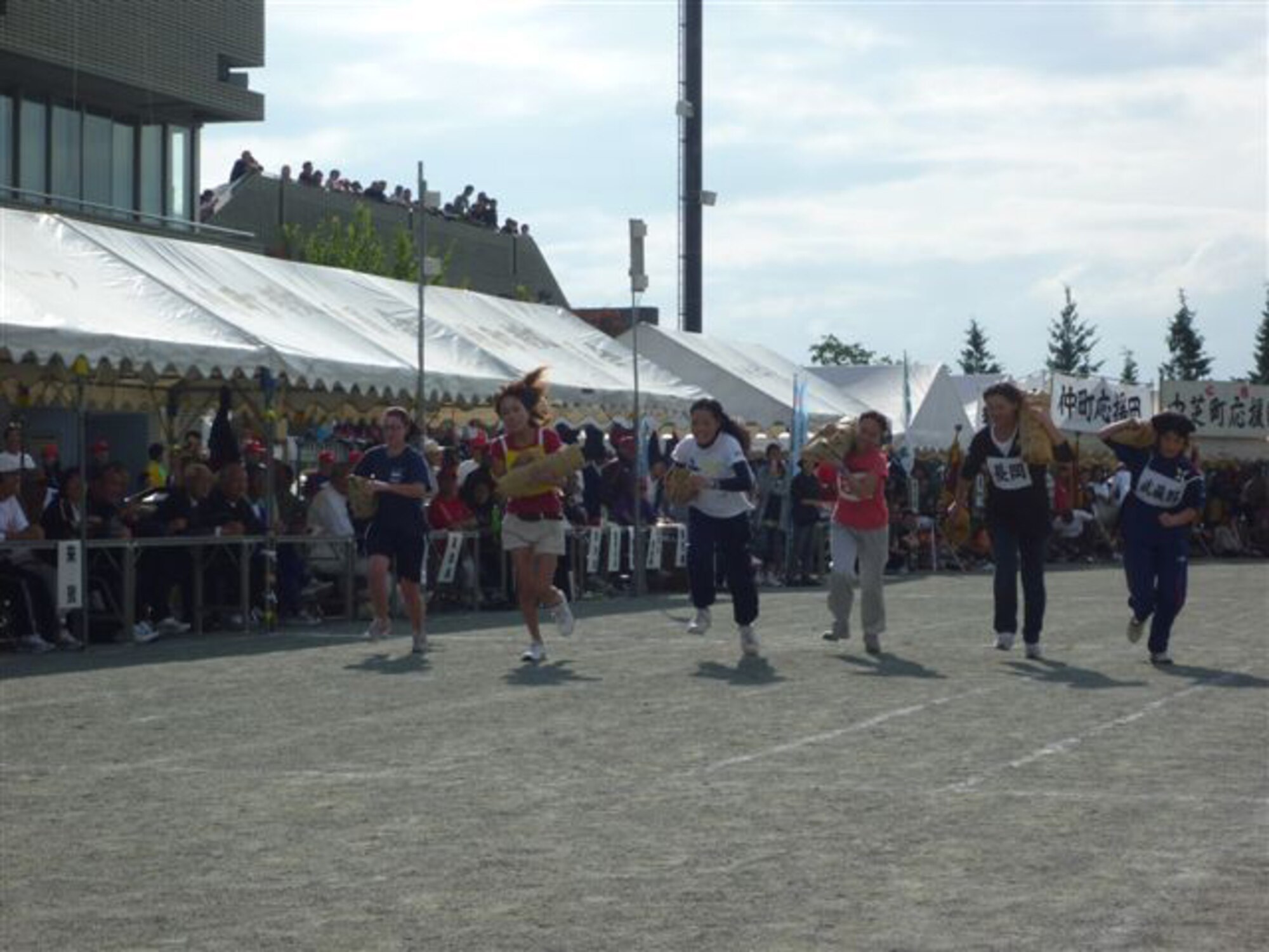 YOKOTA AIR BASE, Japan -- Mizuho Town celebrates the 70th Anniversary as a town with the 51st Mizuho Town Sports Day, Oct. 3.  Members from the 374th Maintenance Group proudly won 1st place during the Rice Bag Carrying Race.(U.S. Air Force photo/Naoko Kurokui)
