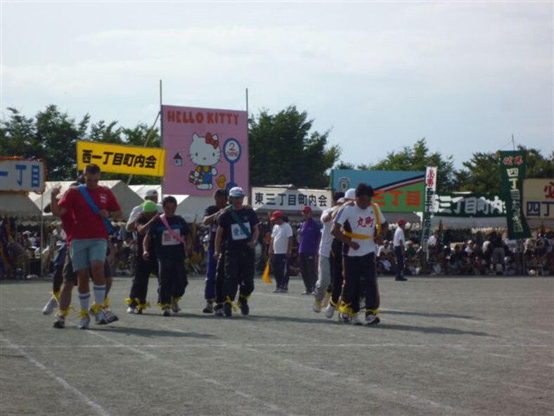 YOKOTA AIR BASE, Japan -- Mizuho town members and members from the 374th Maintenance Group participate in the three legged relay race during the 51st Mizuho Town Sports Day, Oct. 3.  The event was held to celebrate the town's 70th Anniversary, and gave American service members the chance to relax and have fun interacting with the local Japanese people. (U.S. Air Force photo/Naoko Kurokui)
