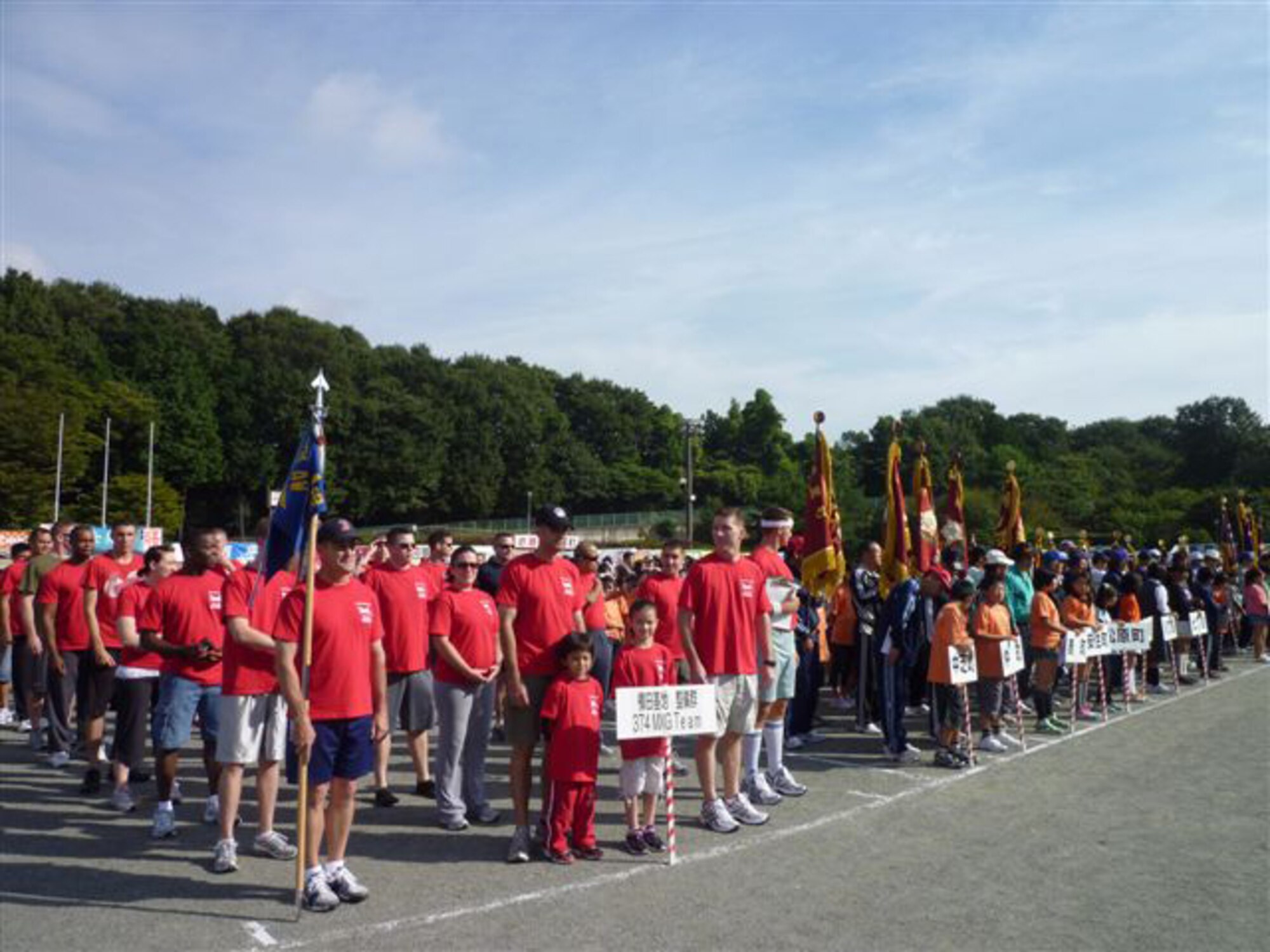 YOKOTA AIR BASE, Japan -- Members from the 374th Maintenance Group Line up for the opening ceremony for Mizuho Town Sports Day with 40 district teams from the town.  The Event was held to celebrate the town's 70th Anniversary, and gave American service members the chance to relax and have fun interacting with the local Japanese people. (U.S. Air Force photo/Naoko Kurokui)