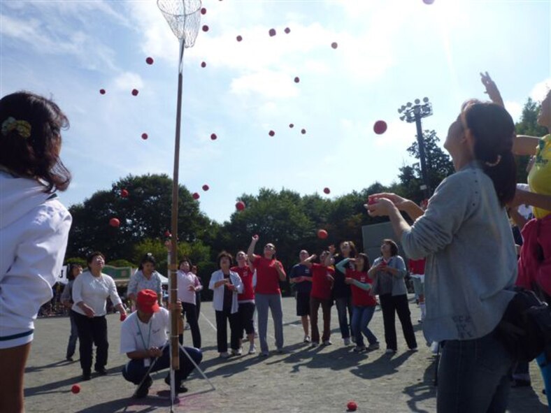 YOKOTA AIR BASE, Japan -- Mizuho Town celebrated the 70th Anniversary as a town with the 51st Mizuho Town Sports Day, Oct. 3. Team members work together to get as many balls as possible into a net during a ball tossing game.(U.S. Air Force photo/Naoko Kurokui)