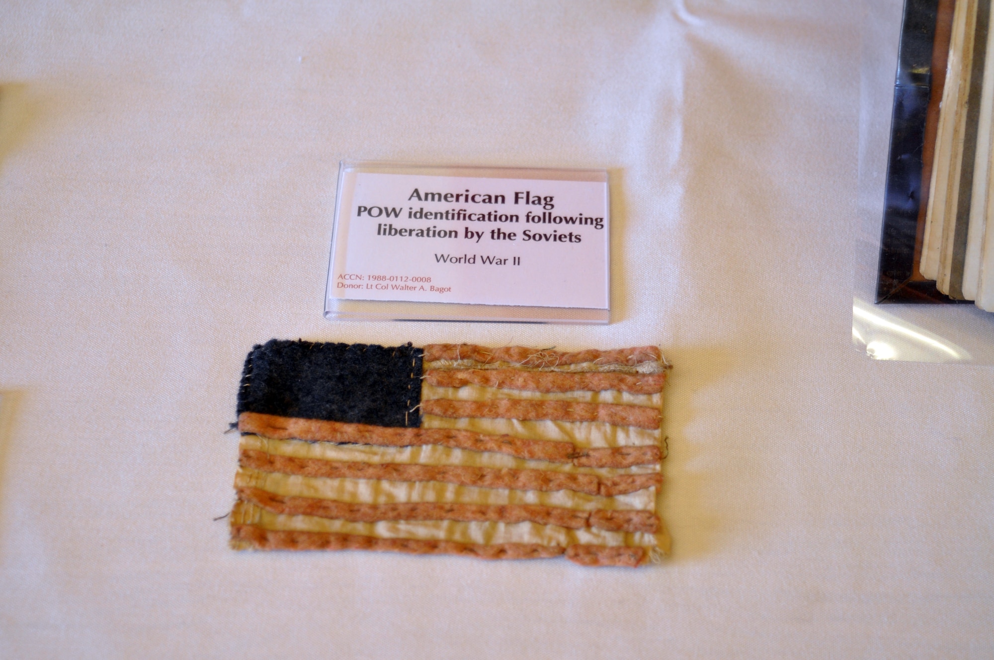 The March Field Museum created a special exhibit of POW/MIA artifacts which they displayed in the Cultural Resource Center lobby. One of the items on display was an American flag that was used to identify POWs following liberation by the Soviets. (U.S. Air Force photo by Linda Welz)

